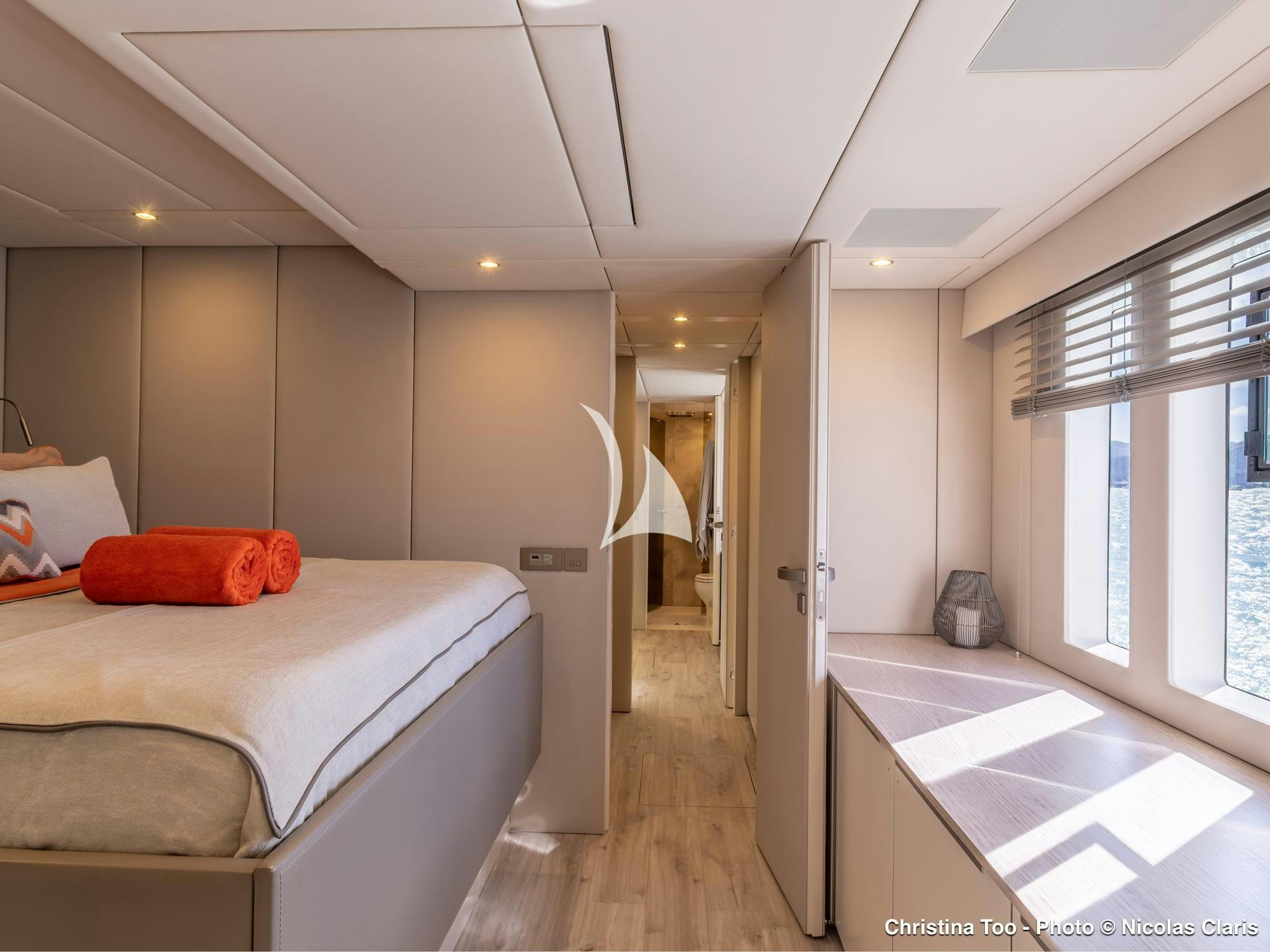 a bedroom with a bed and a window aboard CHRISTINA TOO Yacht for Sale