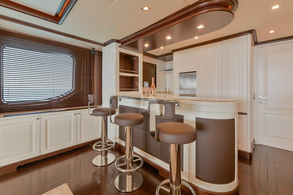a kitchen with stools and stools aboard ELENA NUEVE Yacht for Charter