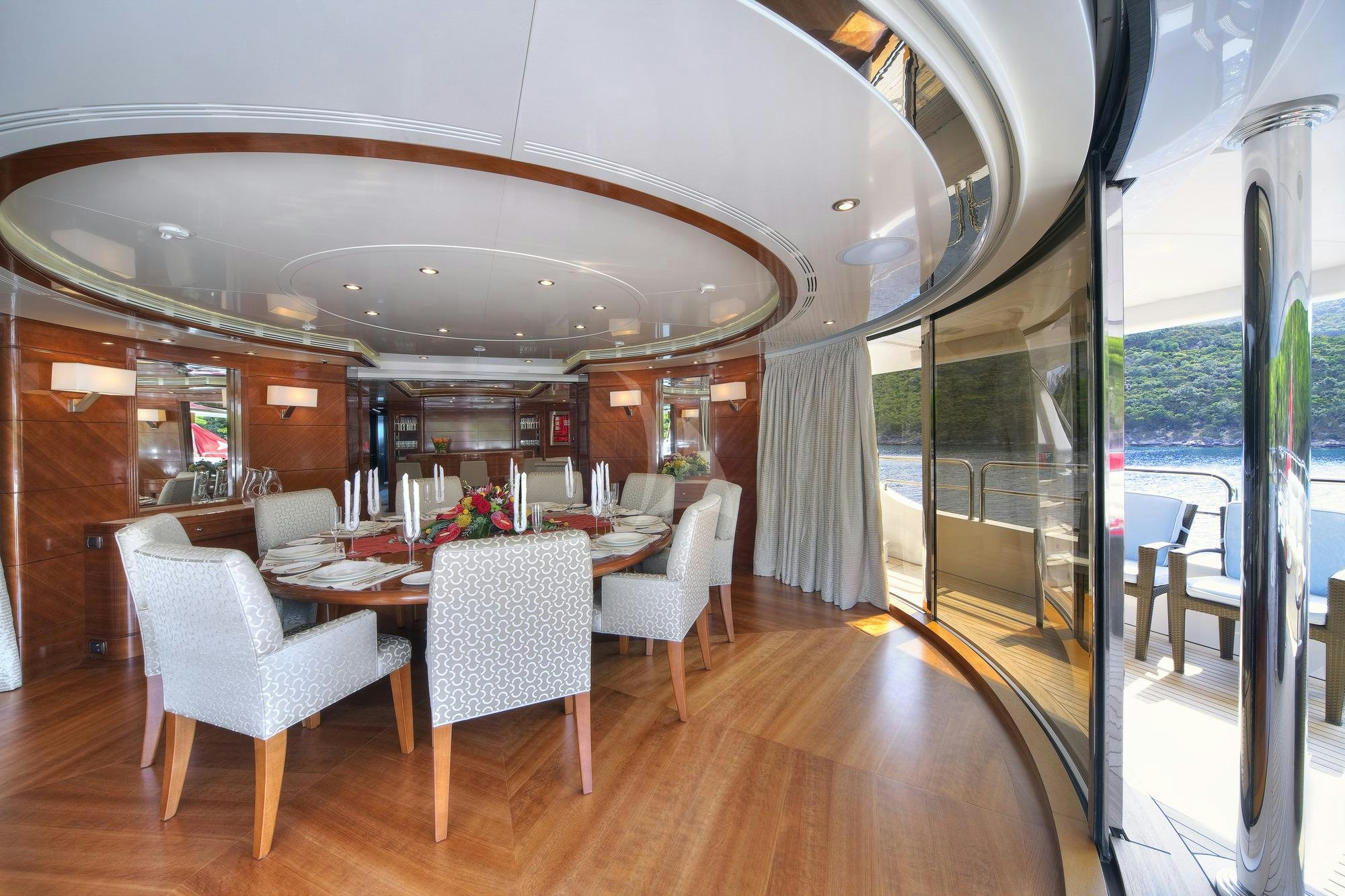a dining room with a large window aboard HARMONY III Yacht for Charter