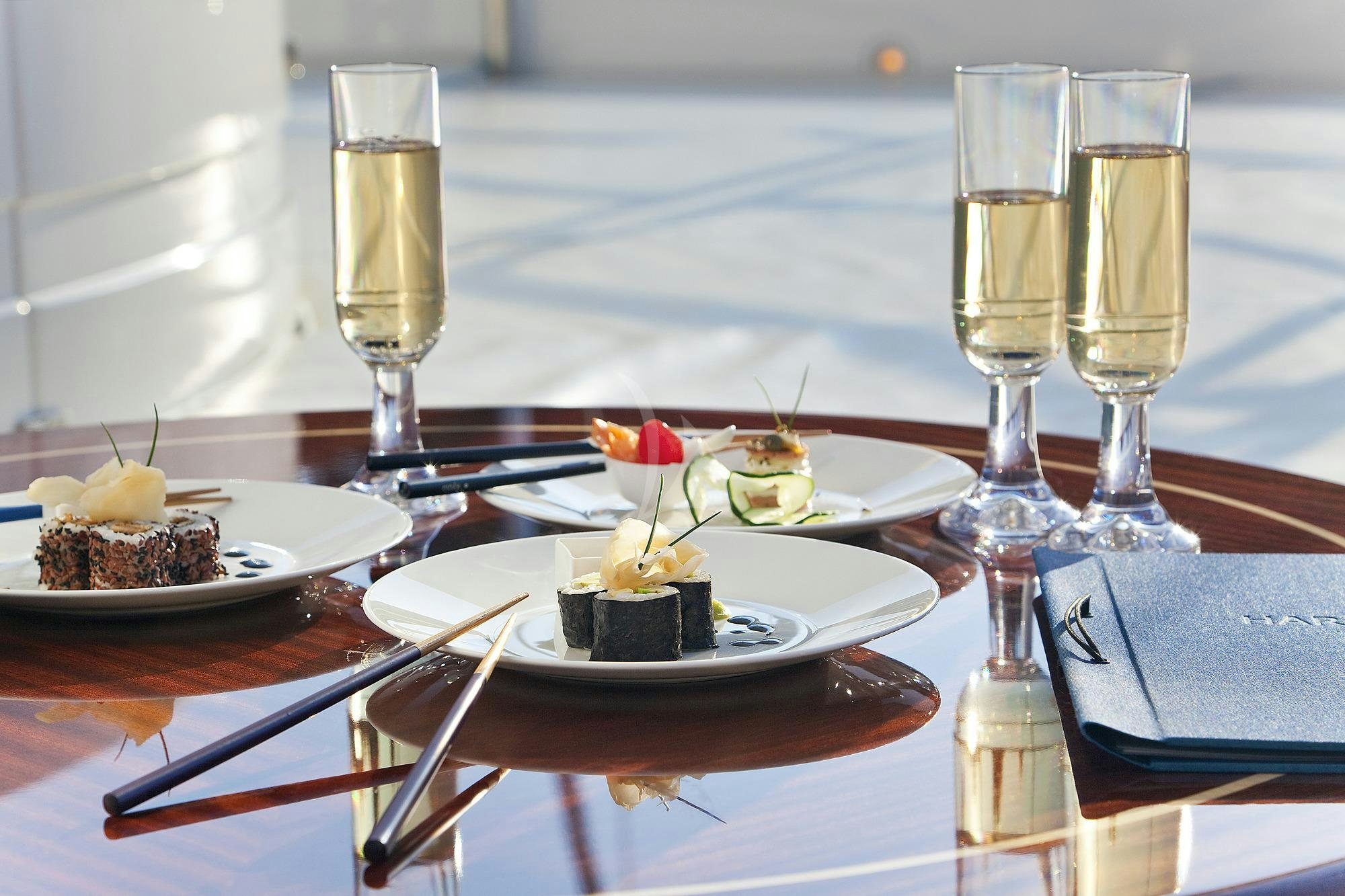 a table with food and wine glasses aboard HARMONY III Yacht for Charter