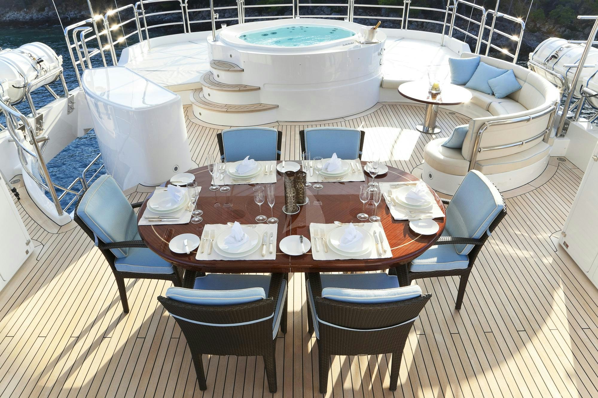 a table set for a dinner aboard HARMONY III Yacht for Charter