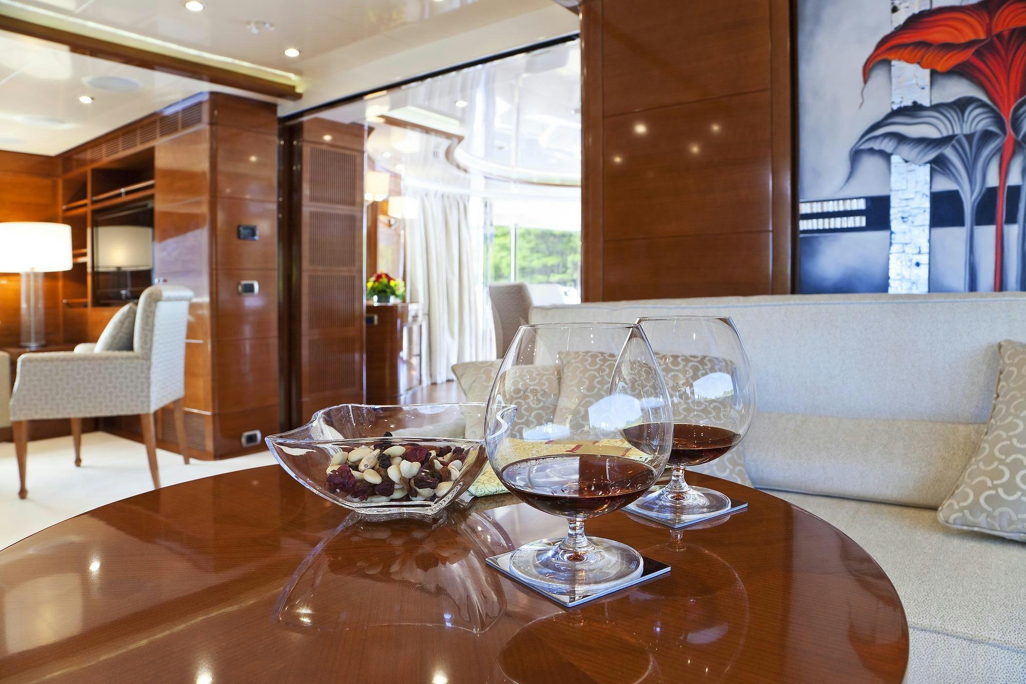a table with glasses and a bowl of food on it aboard HARMONY III Yacht for Charter