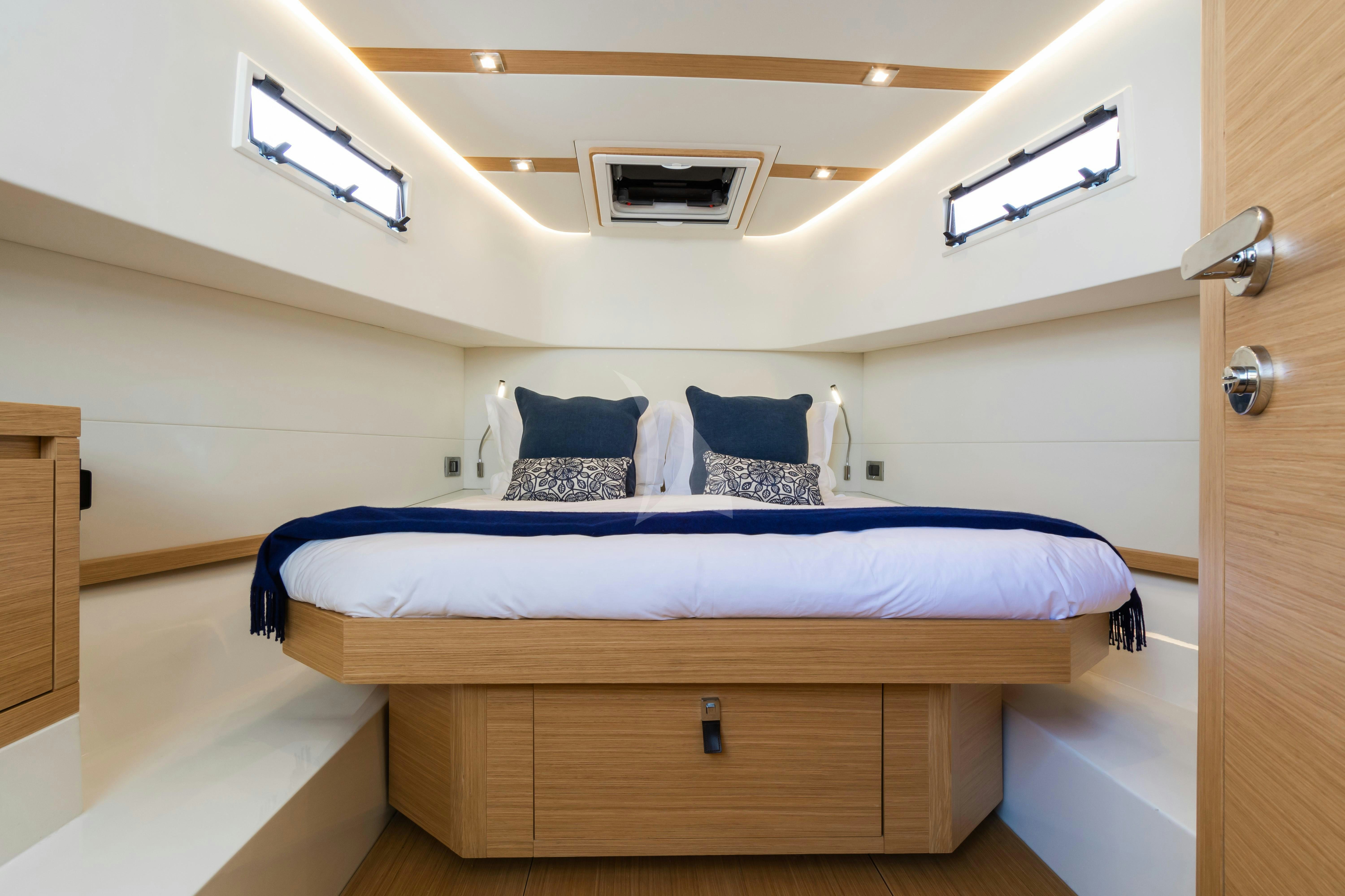 a bedroom with a bed and a desk aboard FLEUR Yacht for Charter