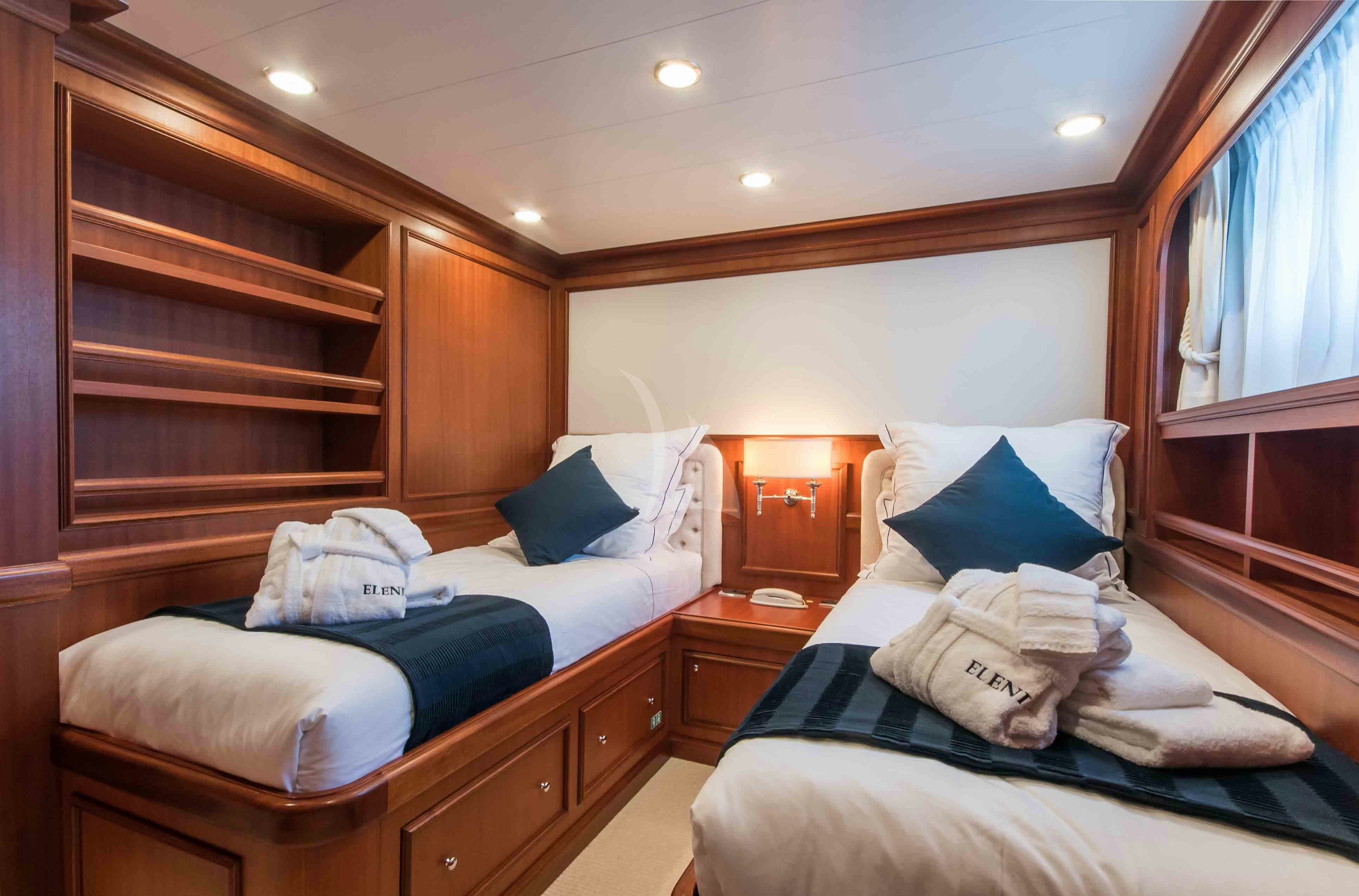 a room with a bed and a dresser aboard ELENI Yacht for Charter