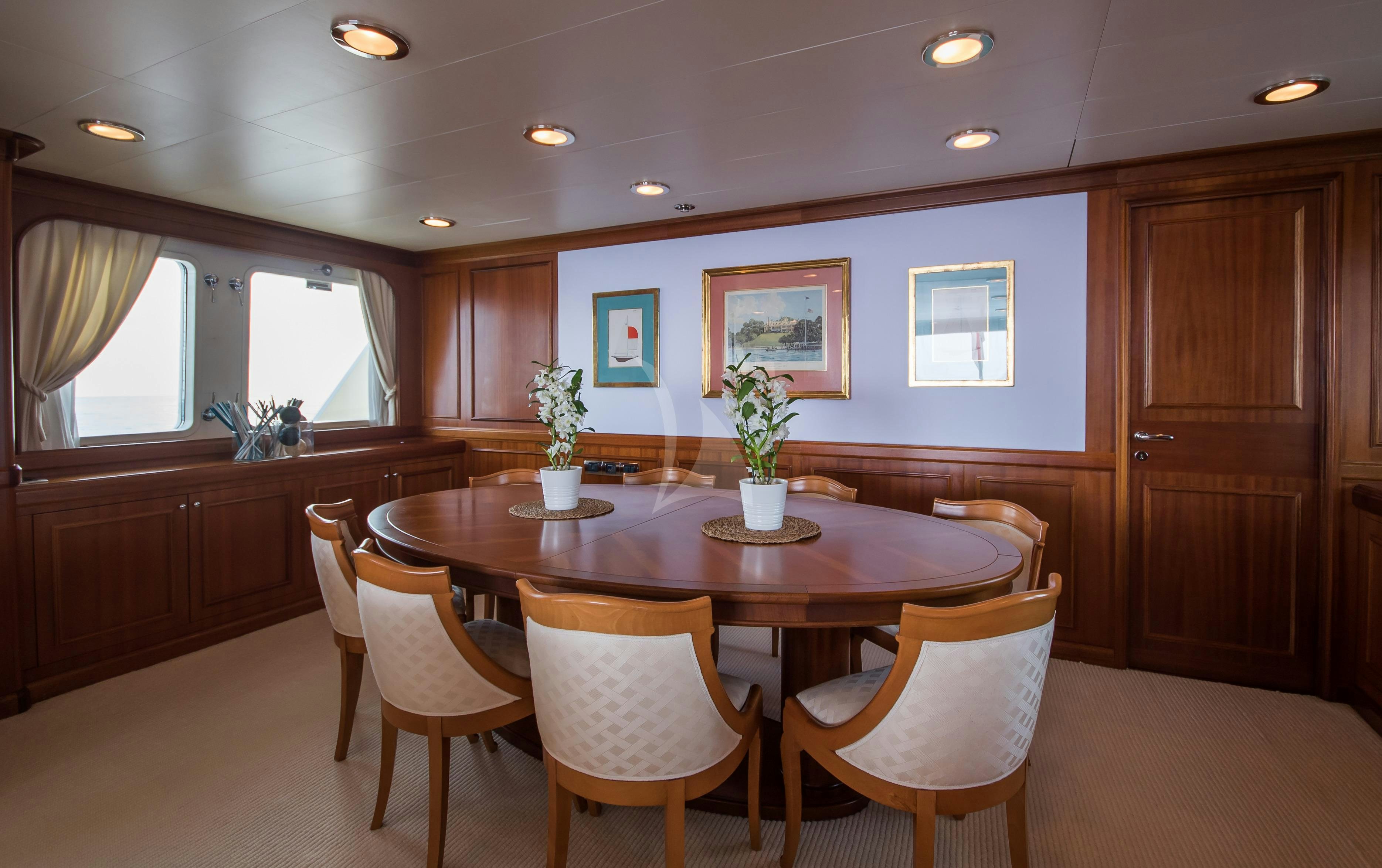a kitchen with a table and chairs aboard ELENI Yacht for Charter