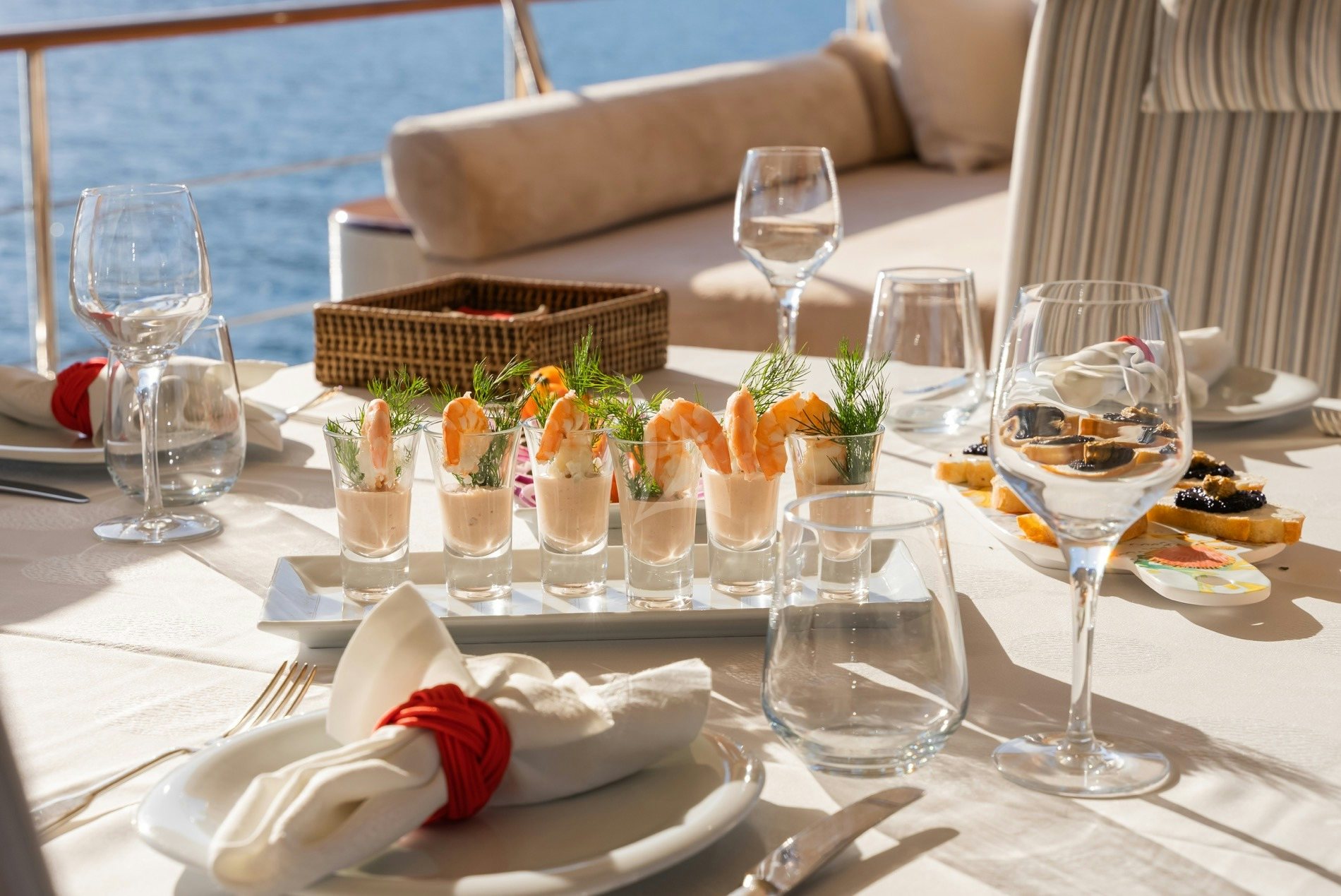 a table with food and glasses aboard DAIMA Yacht for Charter