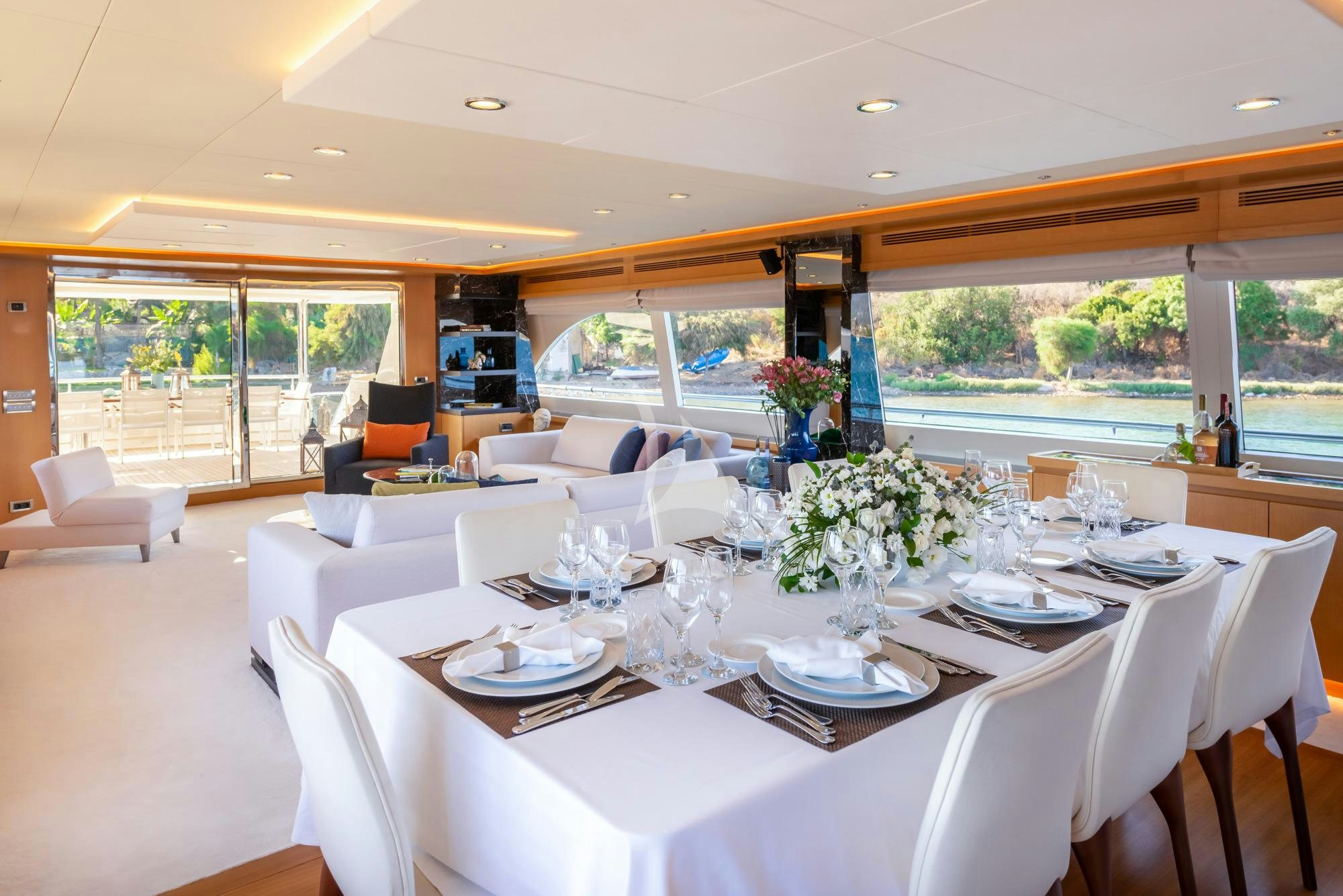 a large dining room with white chairs aboard PANFELISS Yacht for Charter