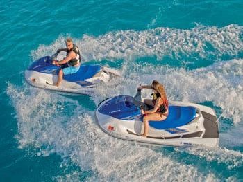 a couple of people on a jet ski in the ocean aboard AQUASITION Yacht for Charter