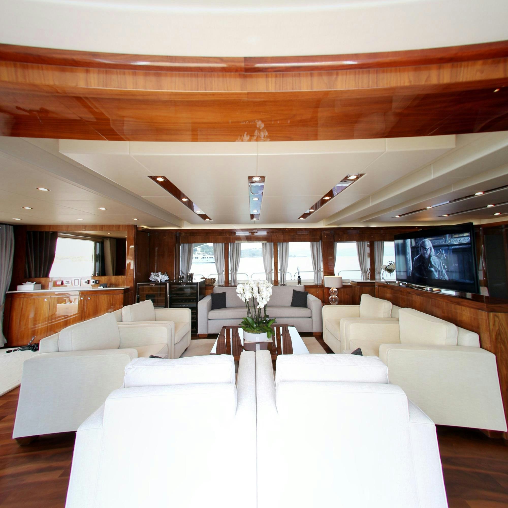 a living room with white couches aboard MAORO Yacht for Charter