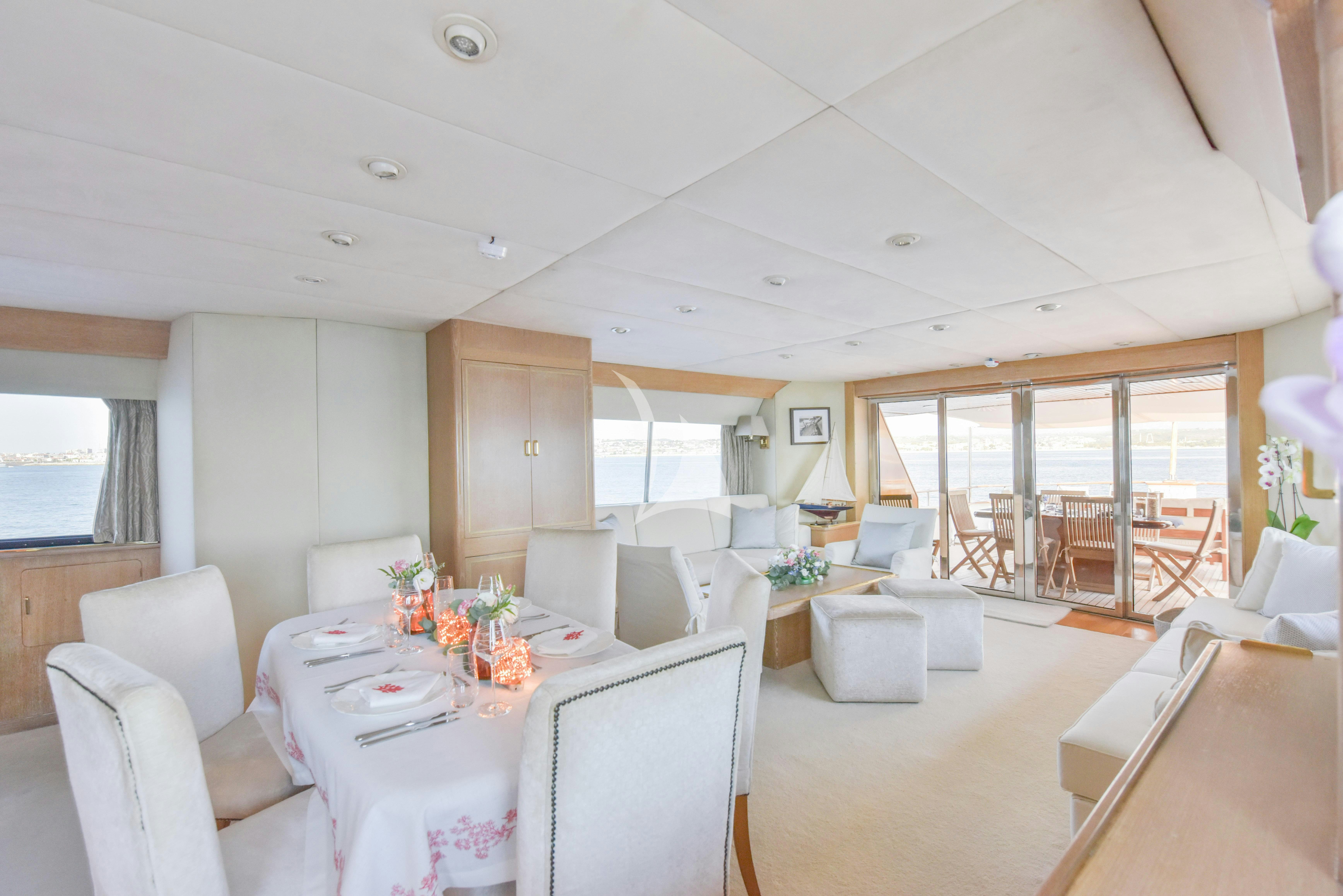 a dining room with a table and chairs aboard ATLANTIC ENDEAVOUR Yacht for Charter