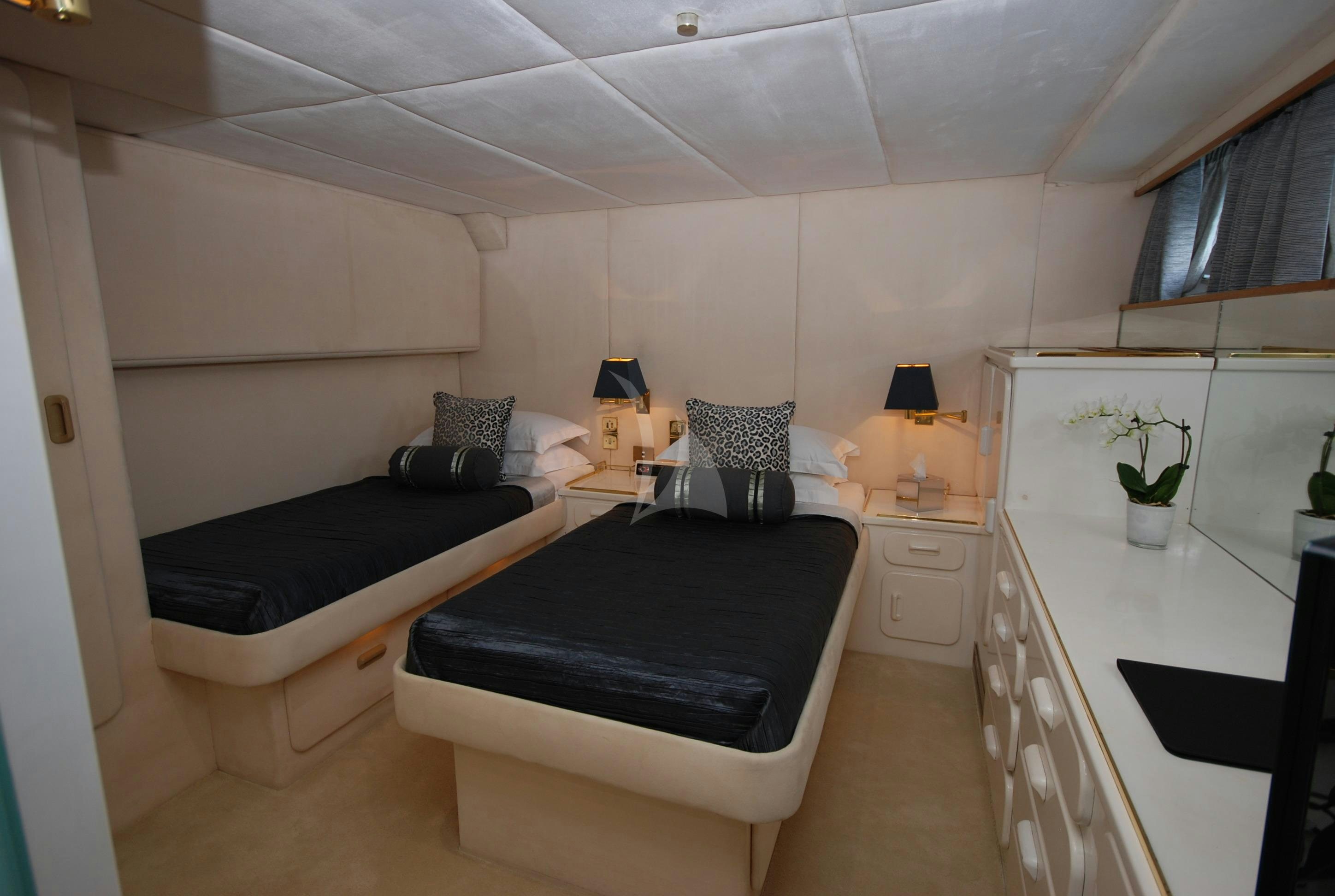a bedroom with a bed and a desk aboard ATLANTIC ENDEAVOUR Yacht for Charter