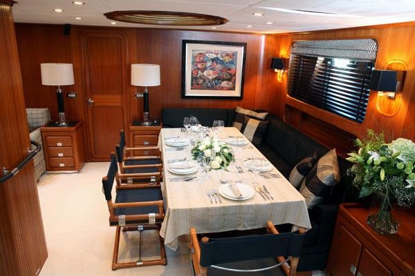 a dining table and chairs in a room aboard GITANA Yacht for Charter