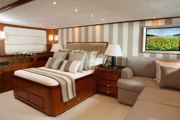 a bedroom with a bed and a couch aboard GITANA Yacht for Charter