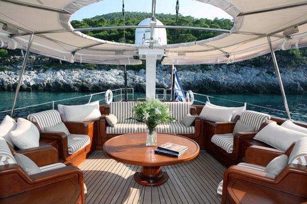 a room with a table and chairs aboard GITANA Yacht for Charter
