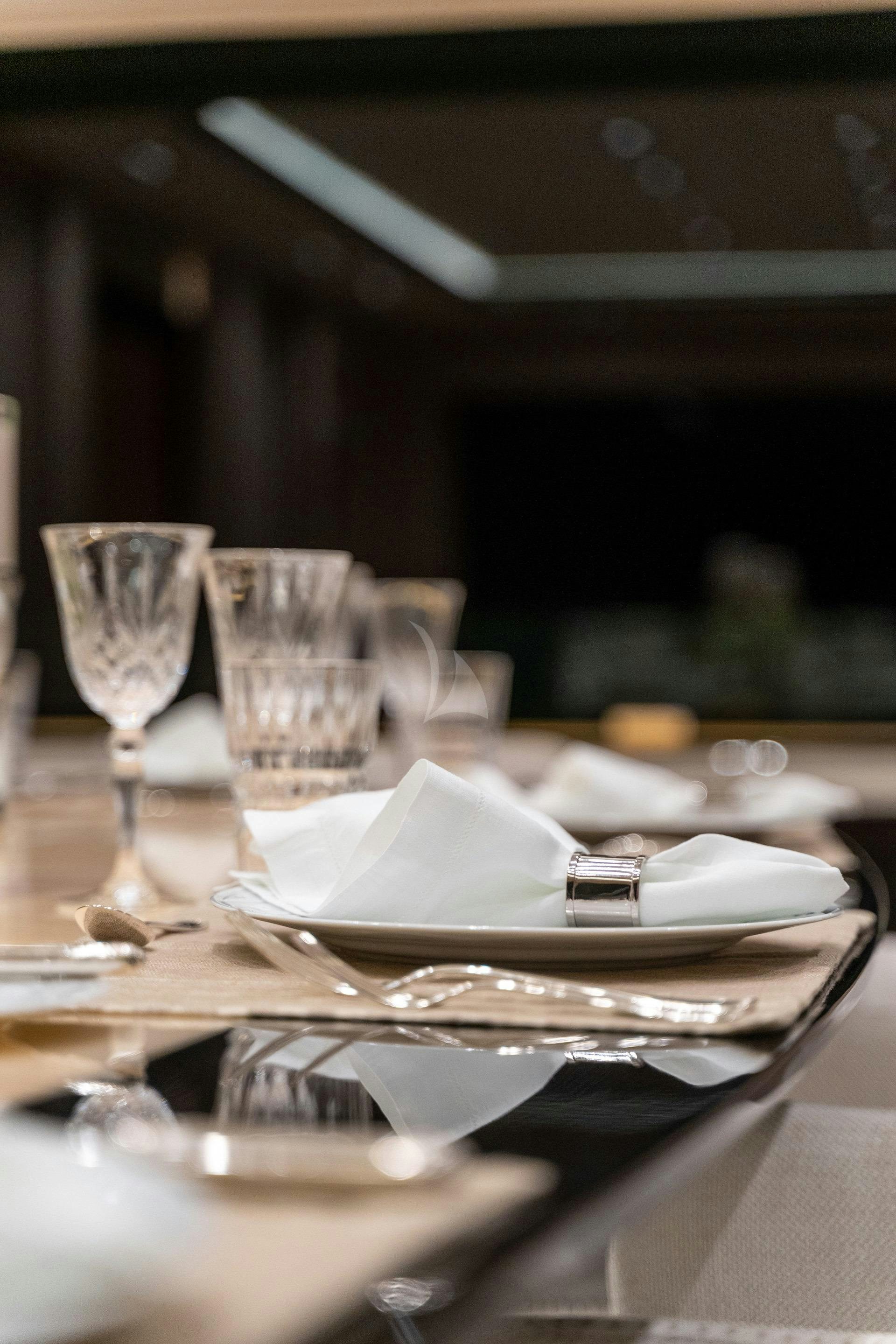 a table with plates and glasses aboard O'MATHILDE Yacht for Charter