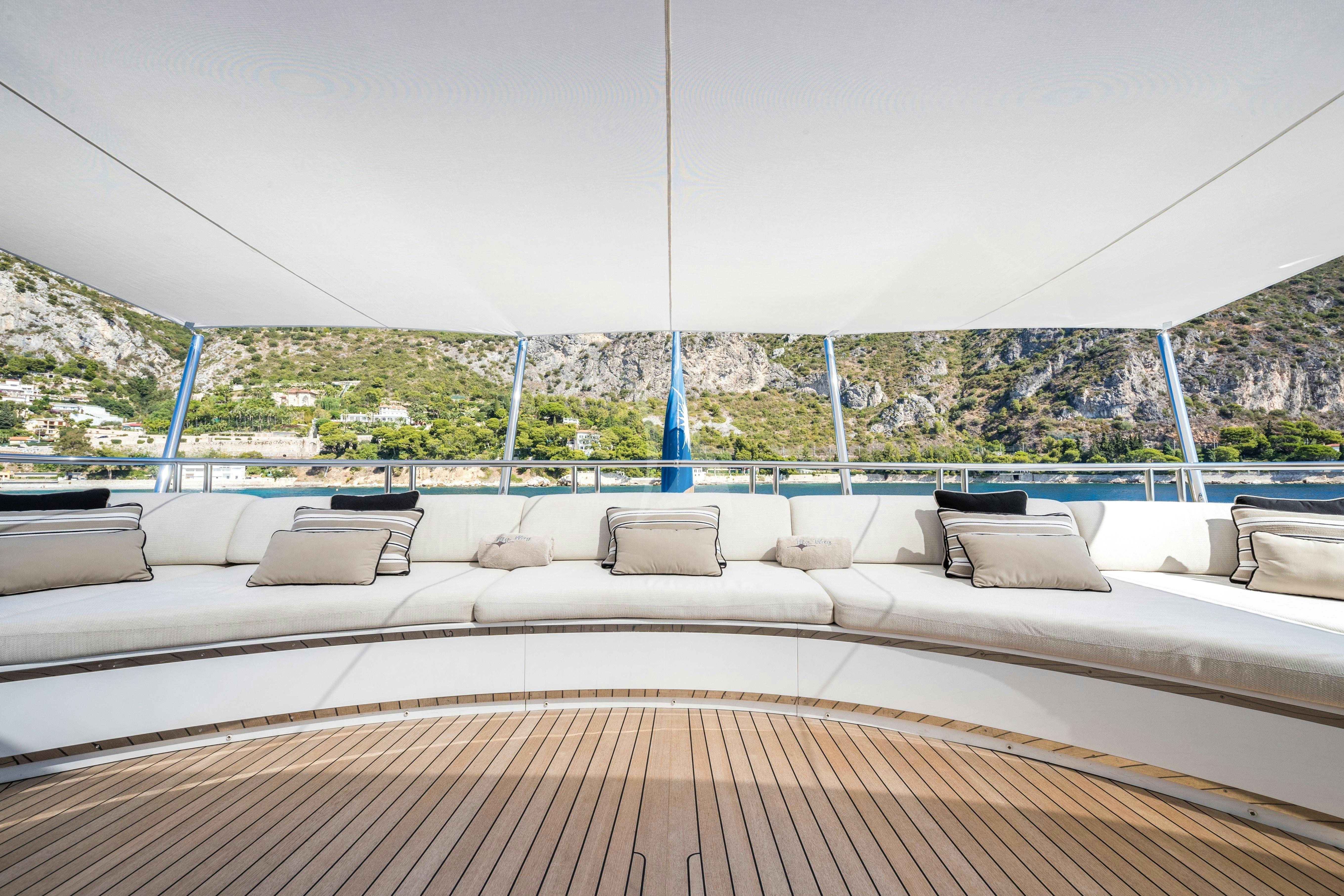 a deck with a view of a city and a large blue tower aboard MY WAY V Yacht for Charter