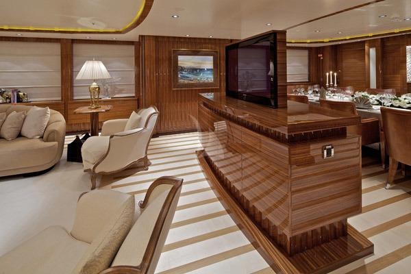 a large living room with a piano aboard MIA RAMA Yacht for Charter