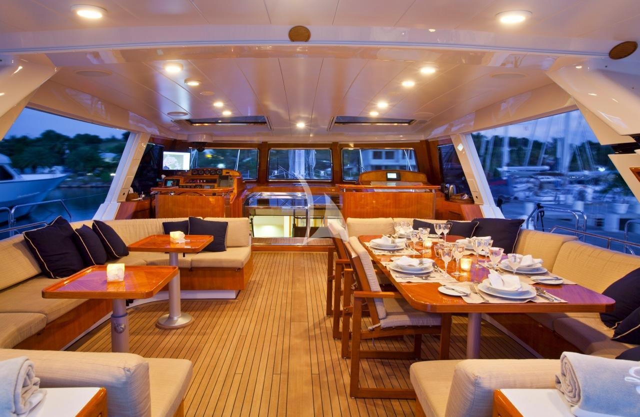 a restaurant with tables and chairs aboard REE Yacht for Charter