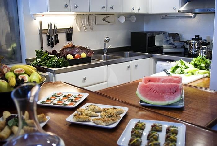 a kitchen with food on the table aboard PAPA JOE Yacht for Charter
