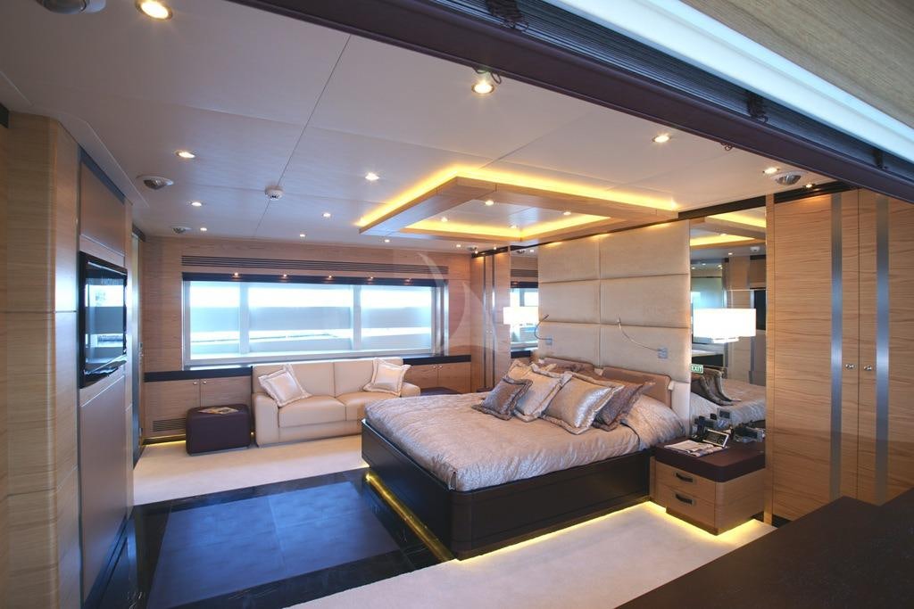 a room with a bed and a couch aboard TATIANA I Yacht for Charter