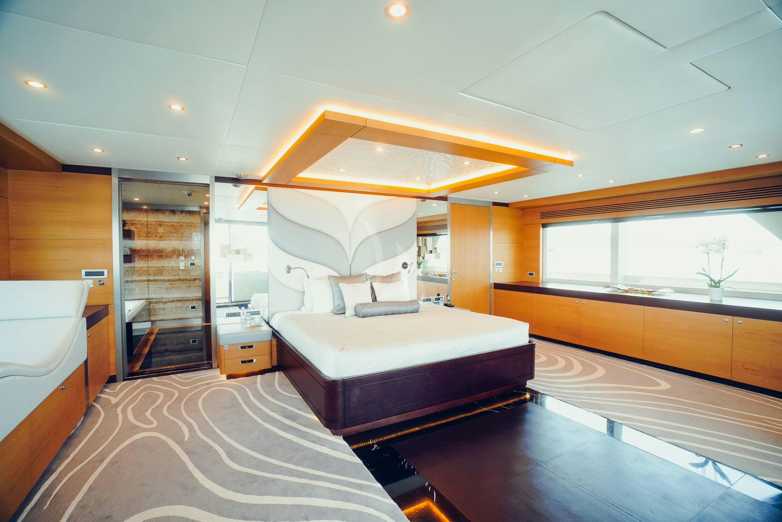 a room with a bed and a window aboard TATIANA I Yacht for Charter