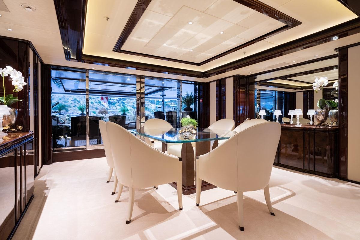 a room with a table and chairs aboard ILLUSION V Yacht for Charter