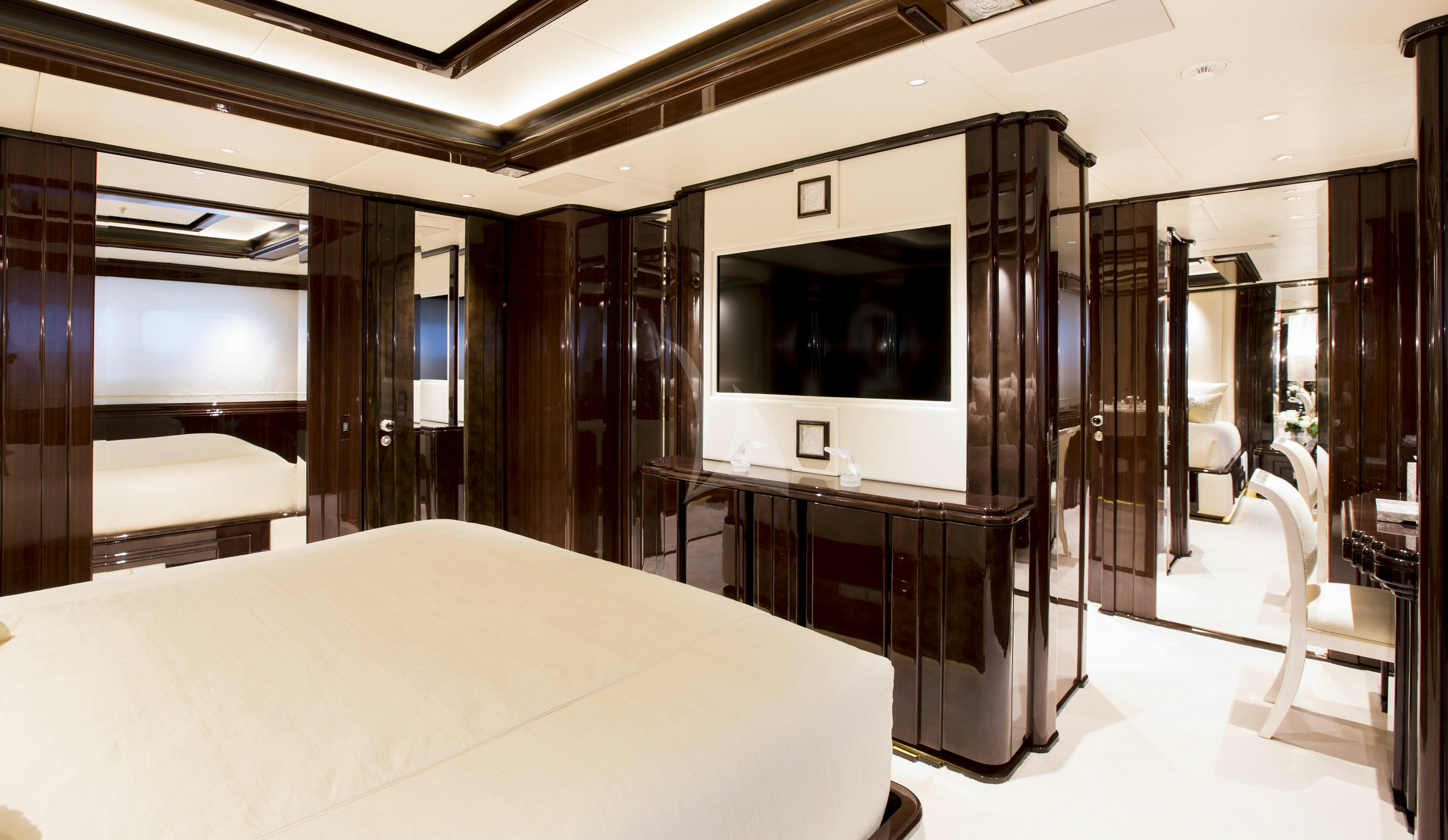 a room with a bed and a desk aboard ILLUSION V Yacht for Charter