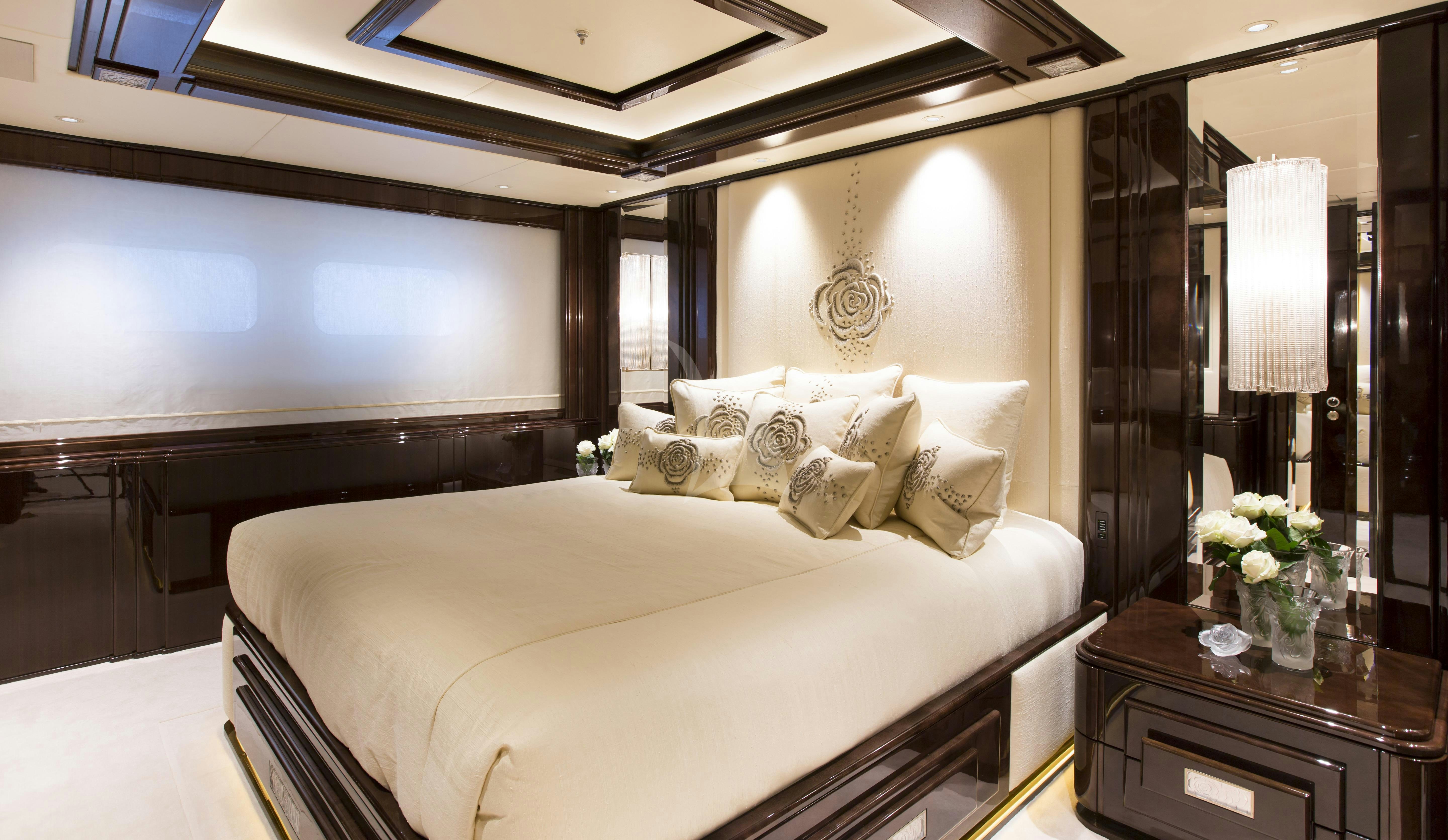 a hotel room with a bed and a desk aboard ILLUSION V Yacht for Charter
