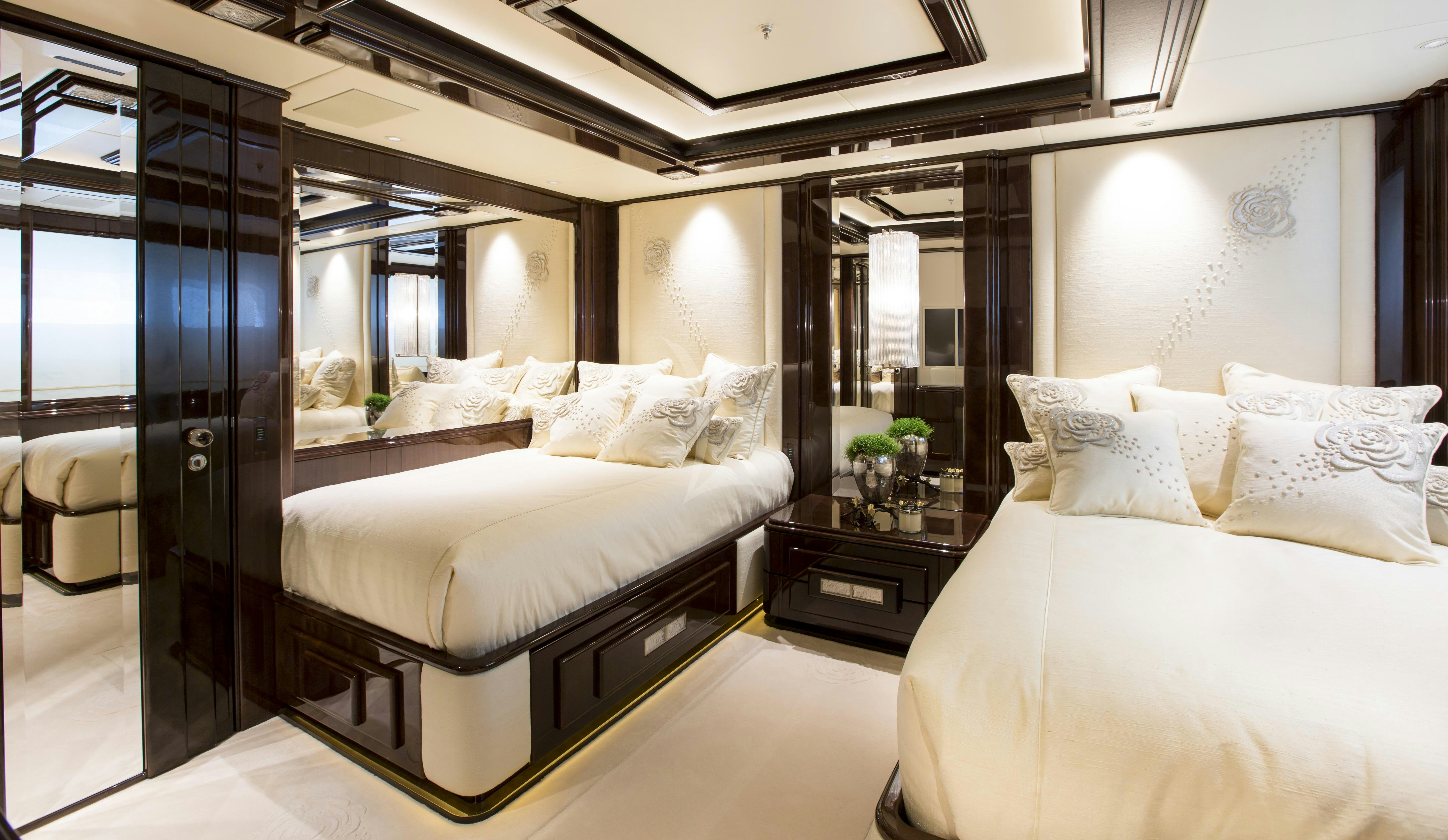 a room with a bed and a mirror aboard ILLUSION V Yacht for Charter