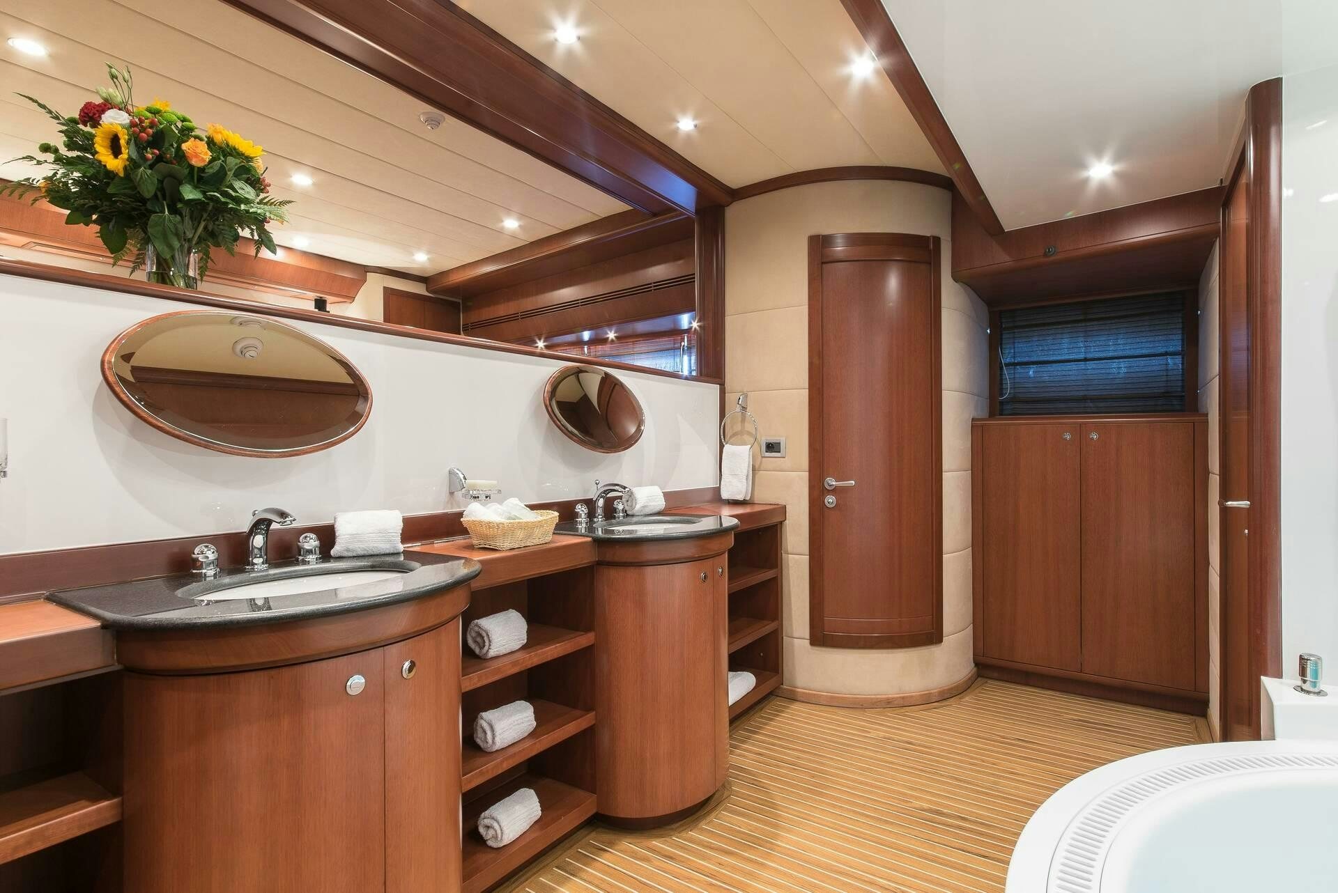 a kitchen with wooden cabinets aboard CLARITY Yacht for Charter