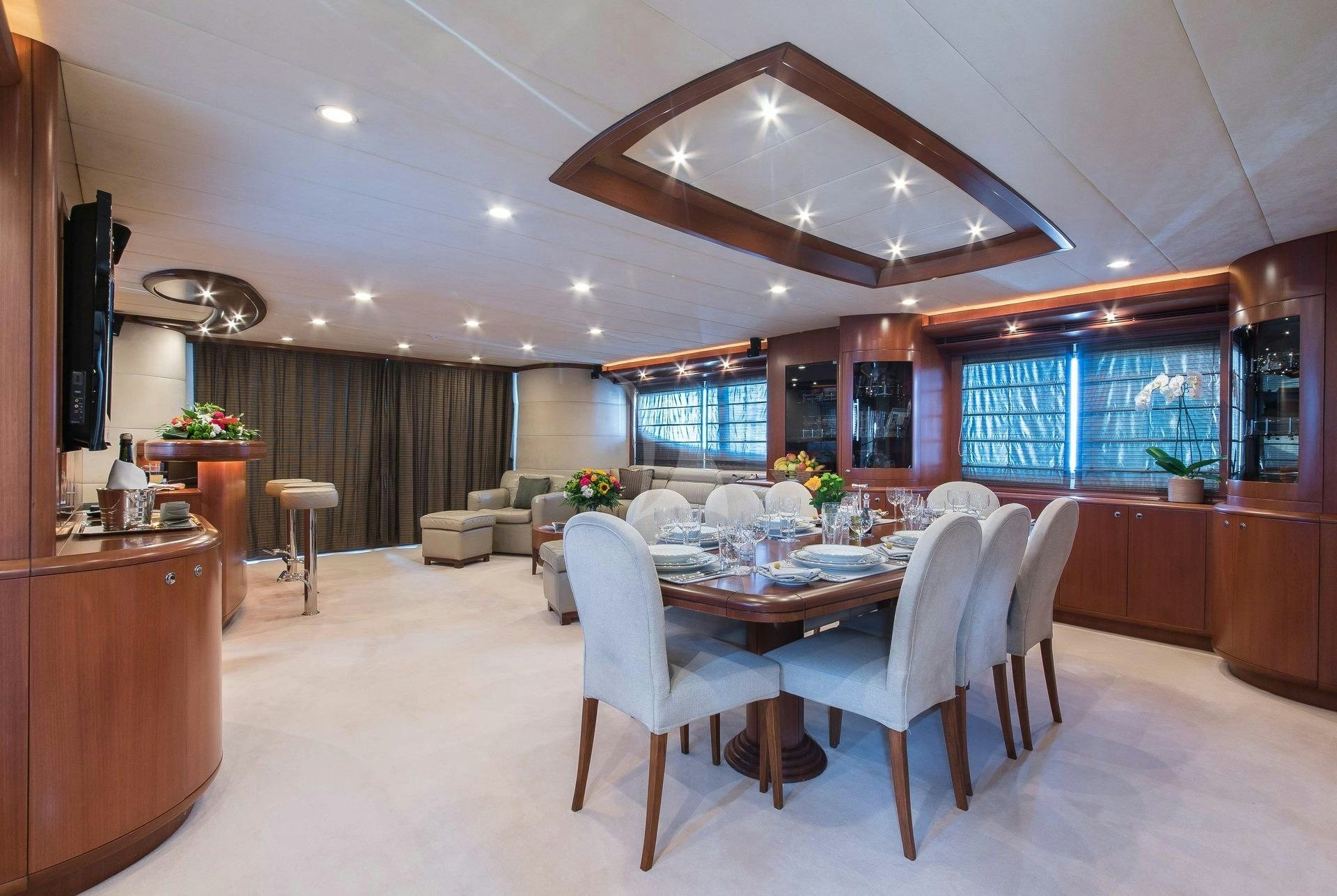 a large room with a table and chairs aboard CLARITY Yacht for Charter