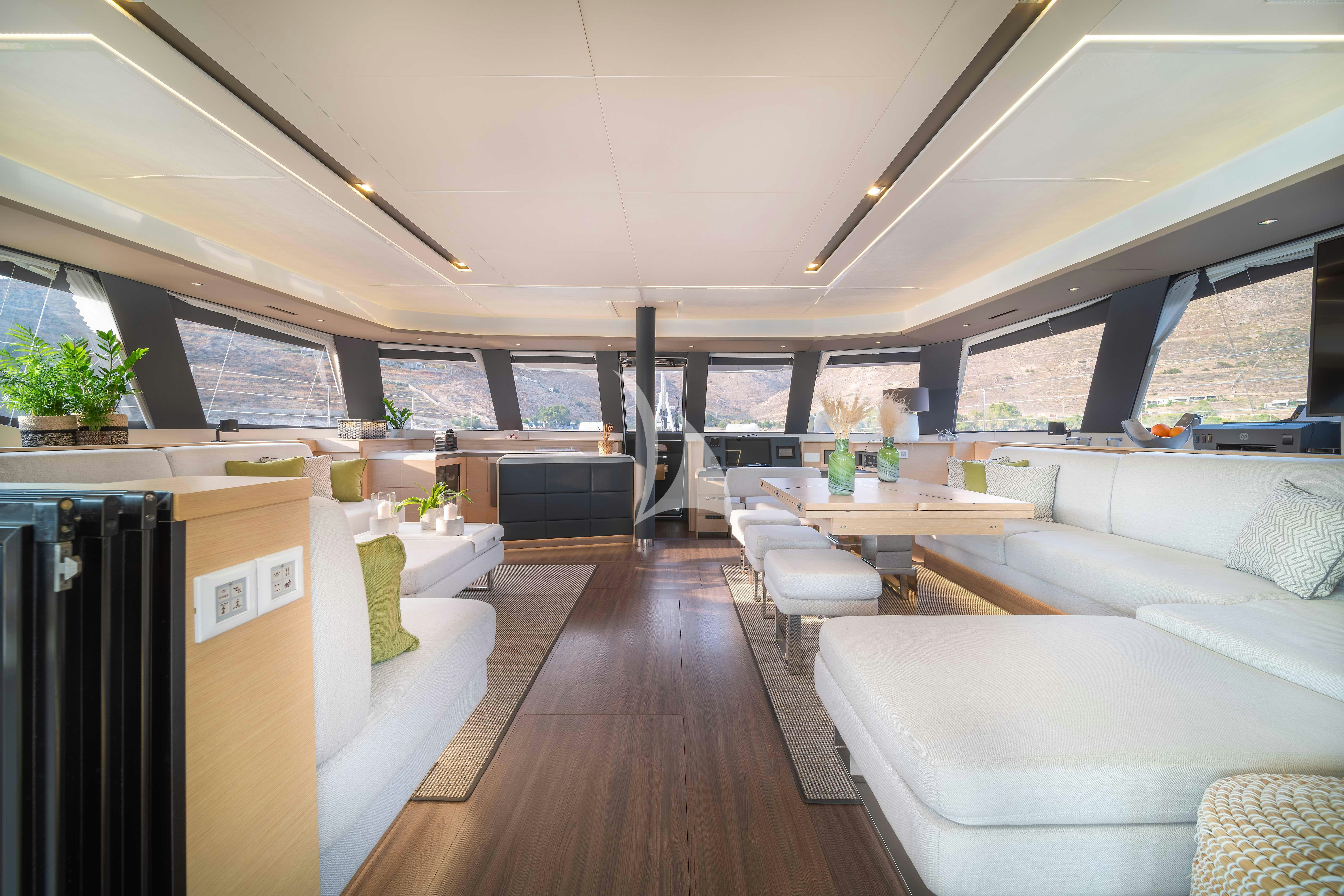 a room with a couch and a table aboard AETHER Yacht for Charter