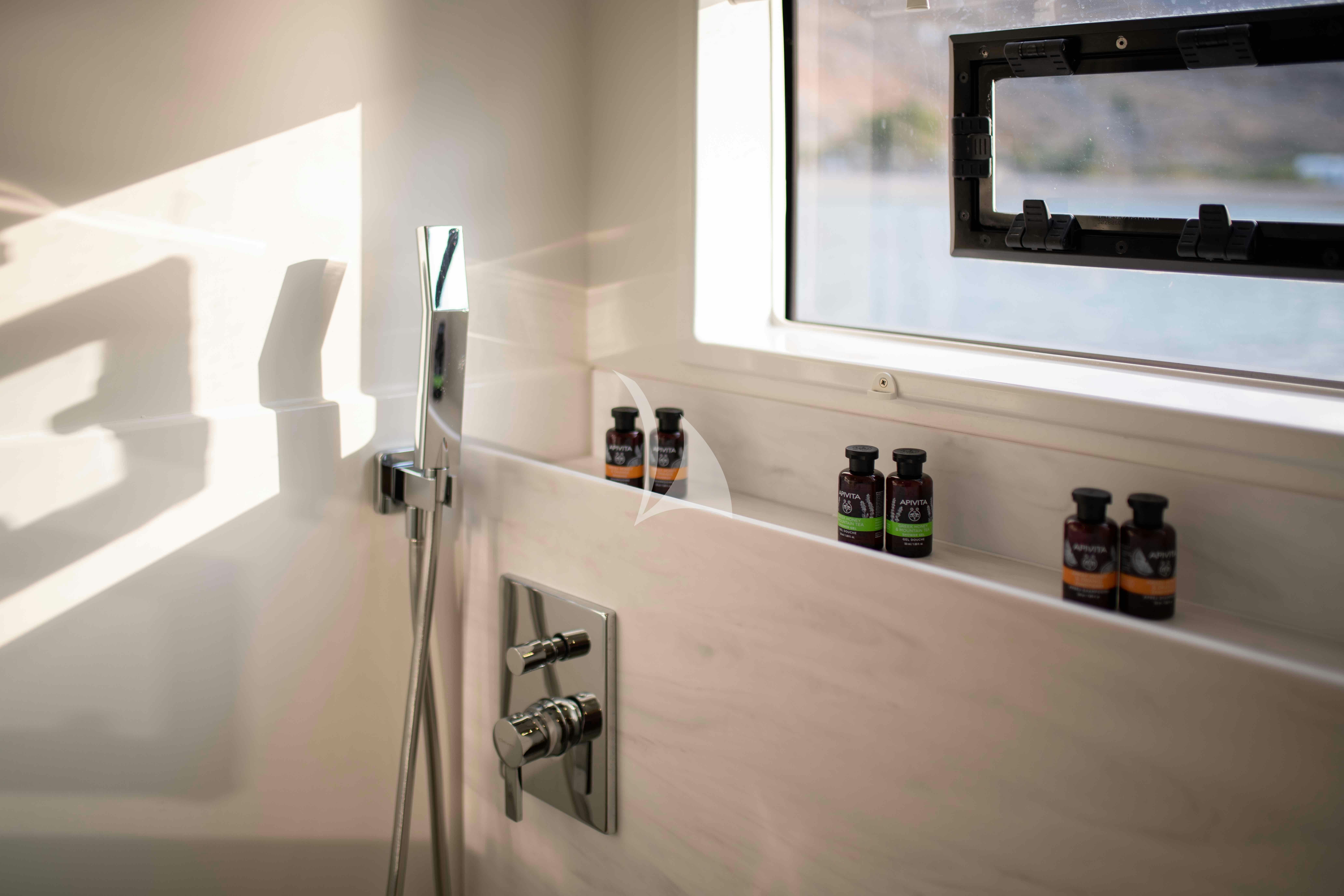 a shelf with bottles and a faucet aboard AETHER Yacht for Charter