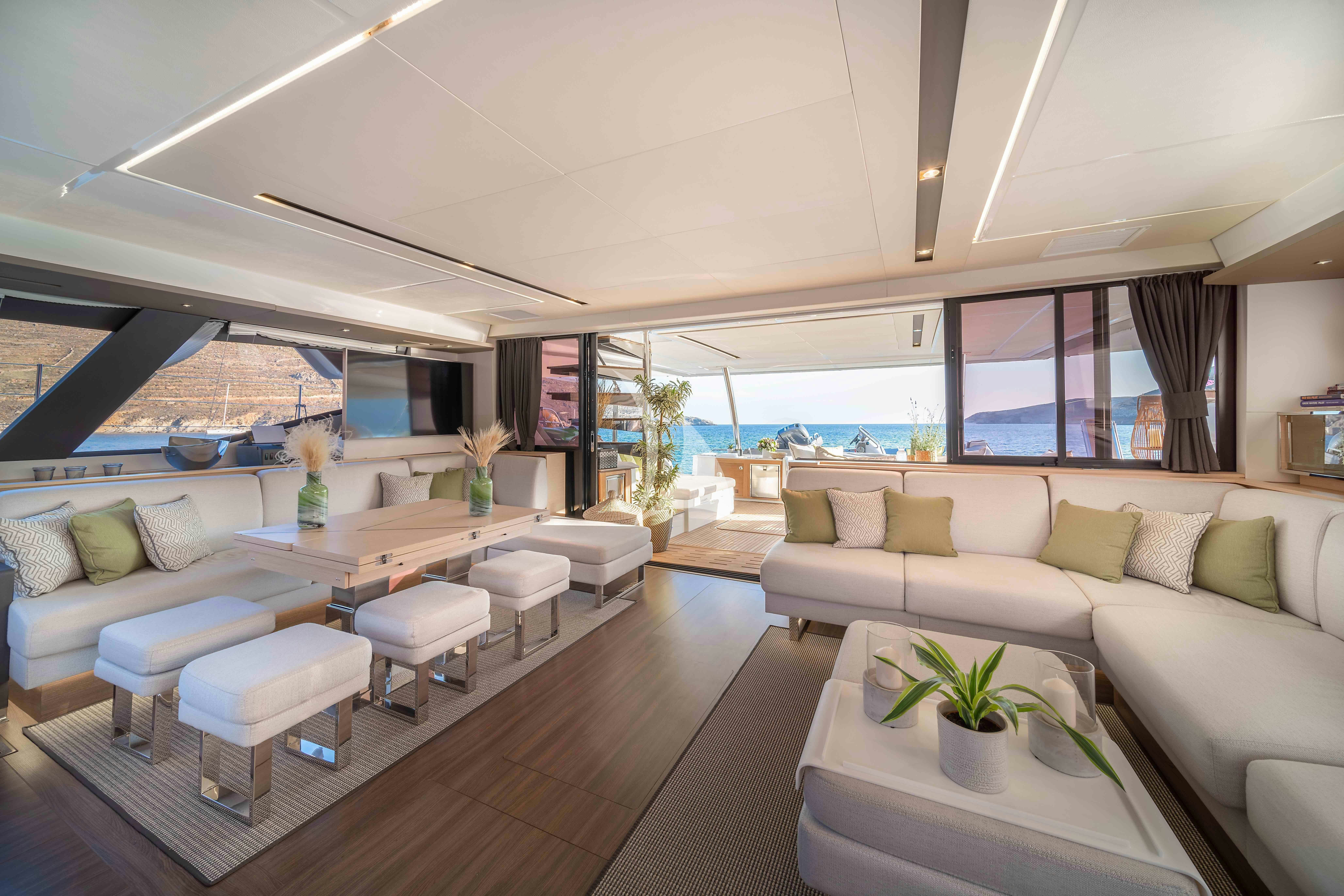a living room with a large window aboard AETHER Yacht for Charter