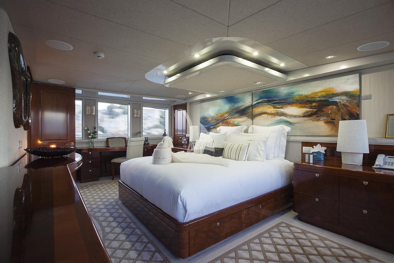 a room with a bed and a desk aboard PRINCESS ILUKA Yacht for Charter