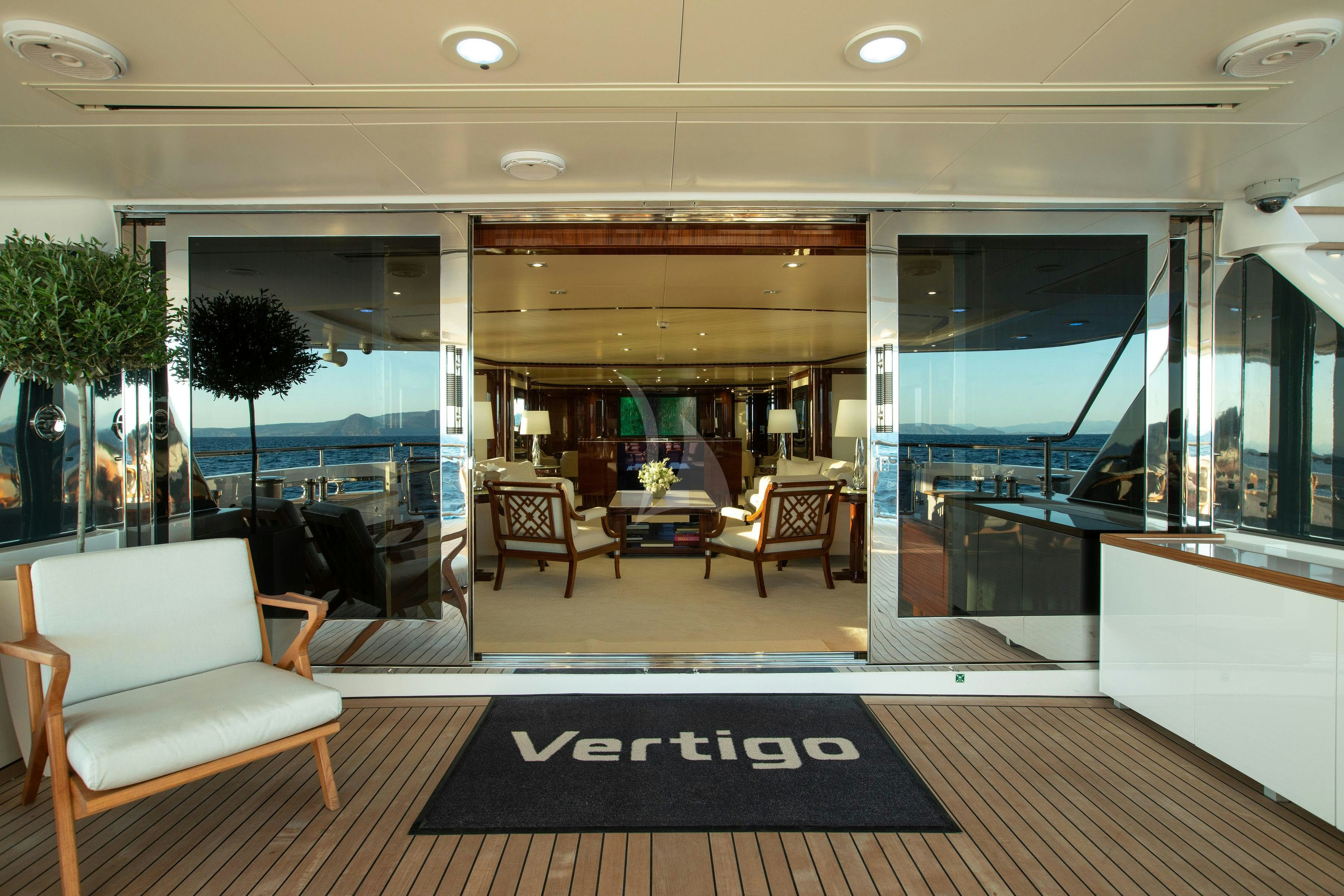 a room with chairs and a table aboard VERTIGO Yacht for Charter
