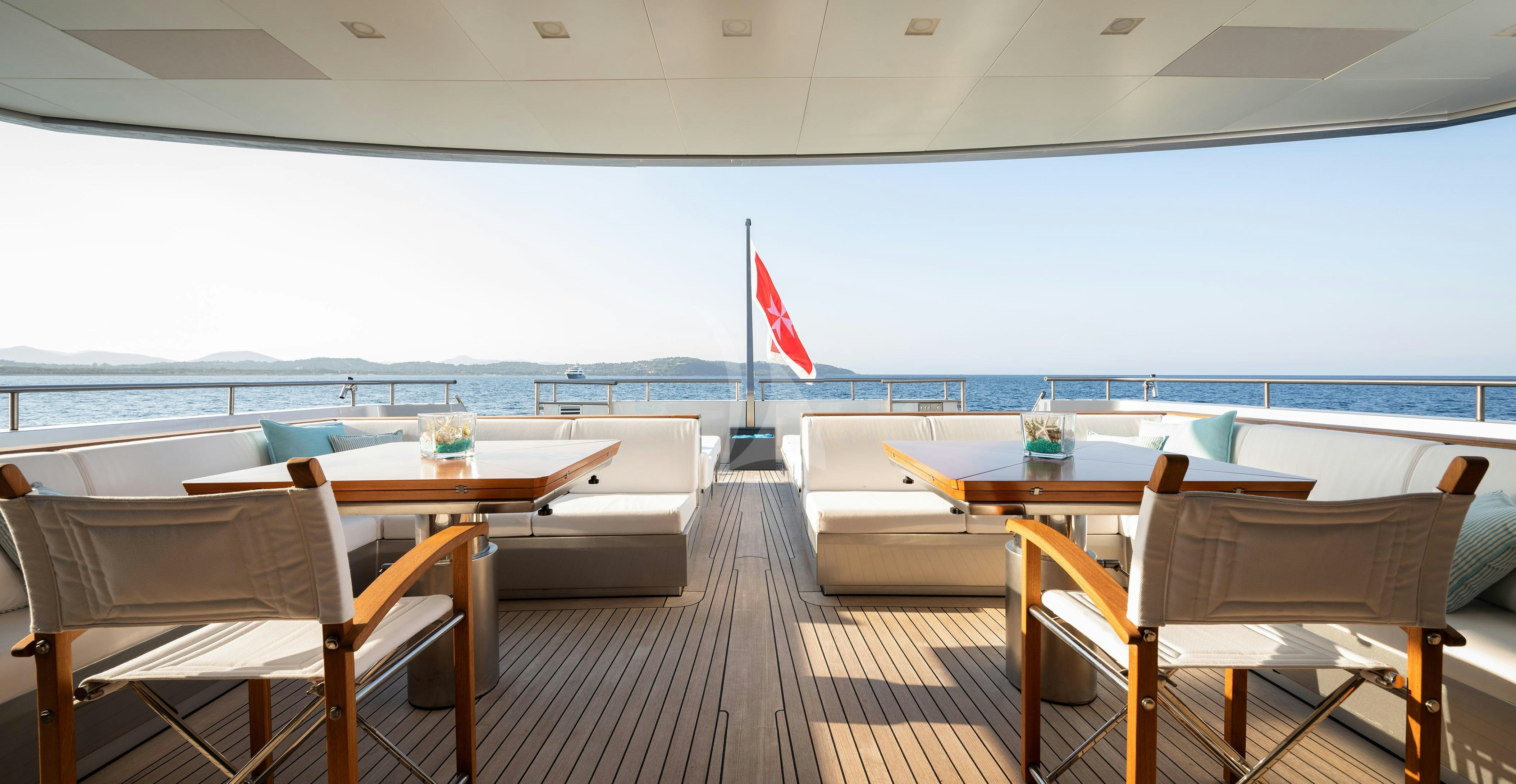 a room with tables and chairs aboard FALCO MOSCATA Yacht for Charter