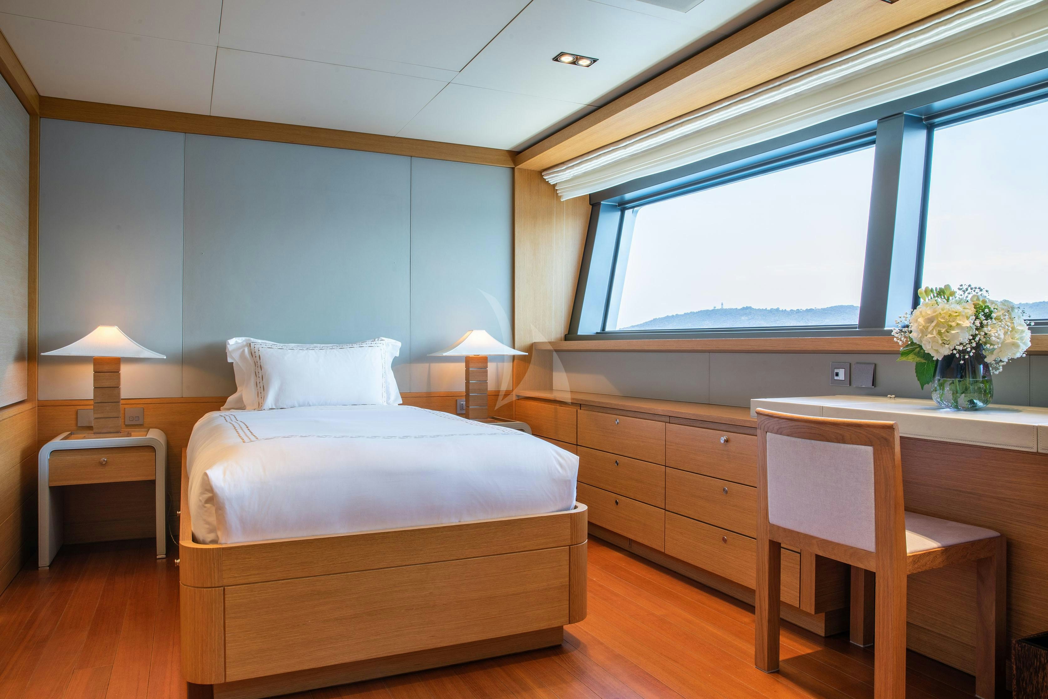 a bedroom with a bed and a desk aboard FALCO MOSCATA Yacht for Charter