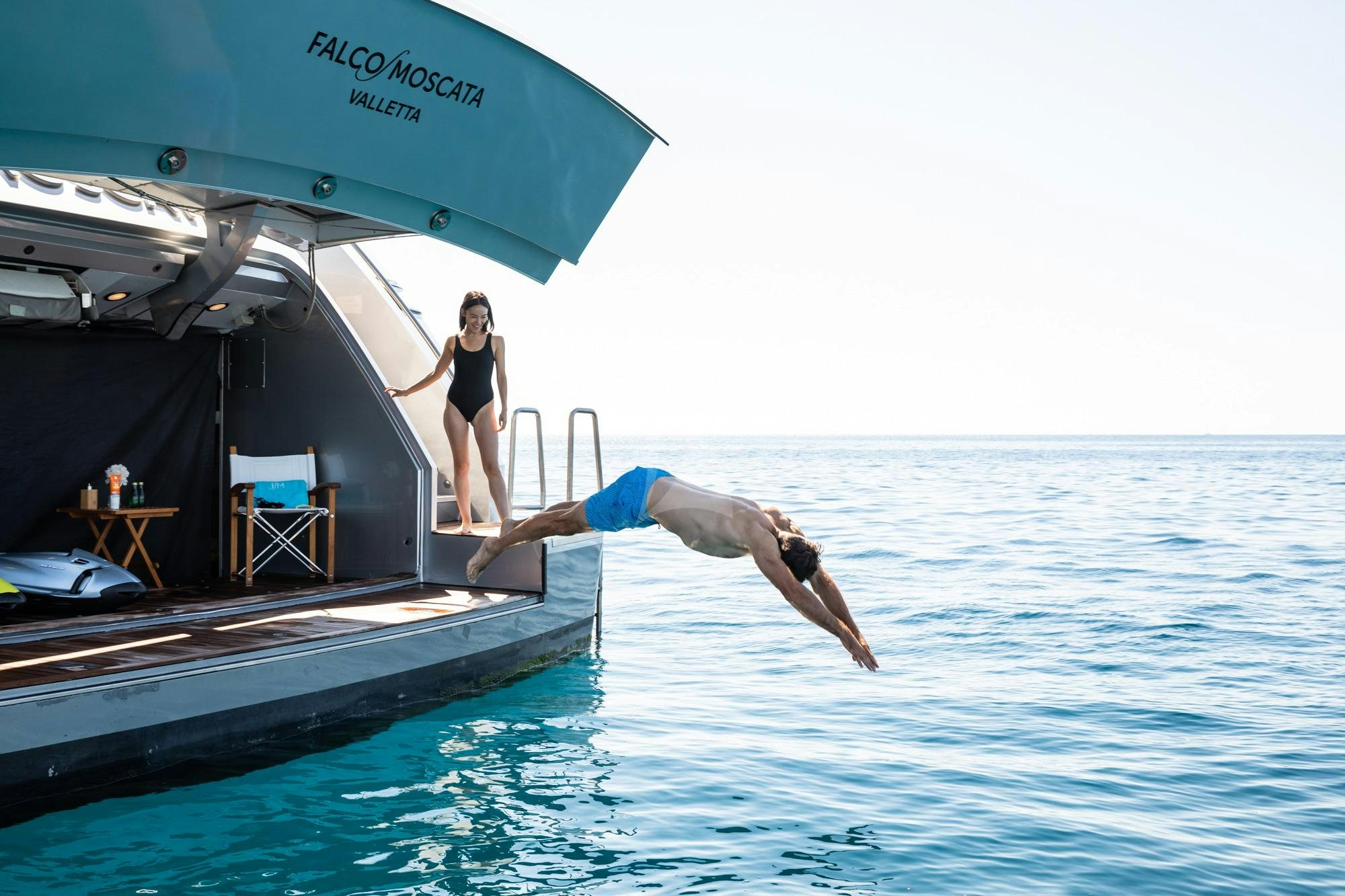 a person jumping out of a boat aboard FALCO MOSCATA Yacht for Charter