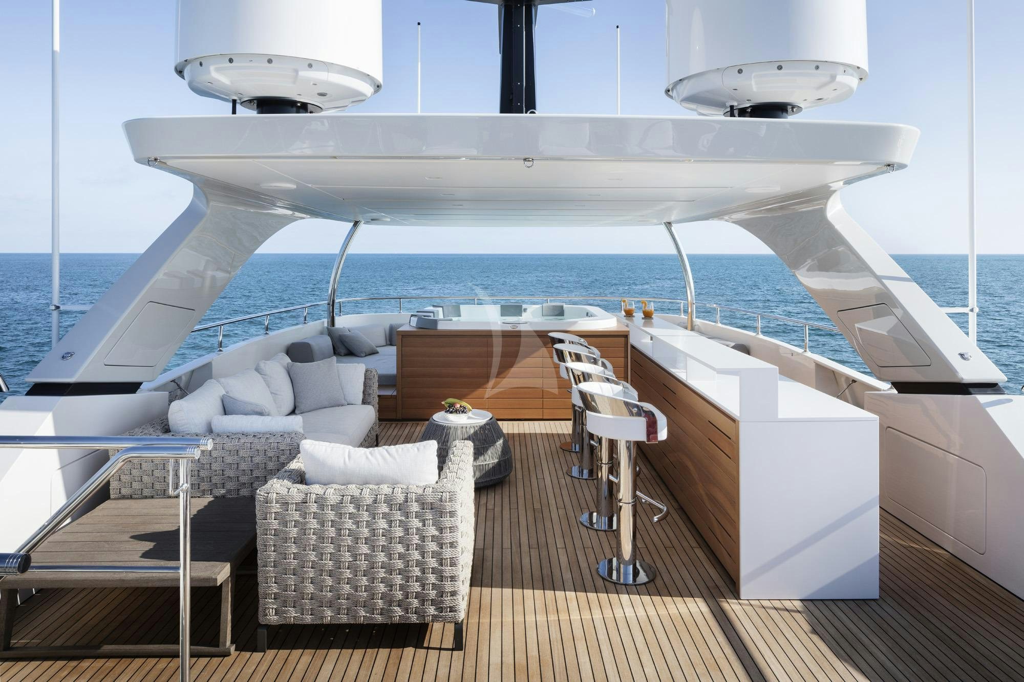 a deck with chairs and a plane in the background aboard NAMASTE Yacht for Charter