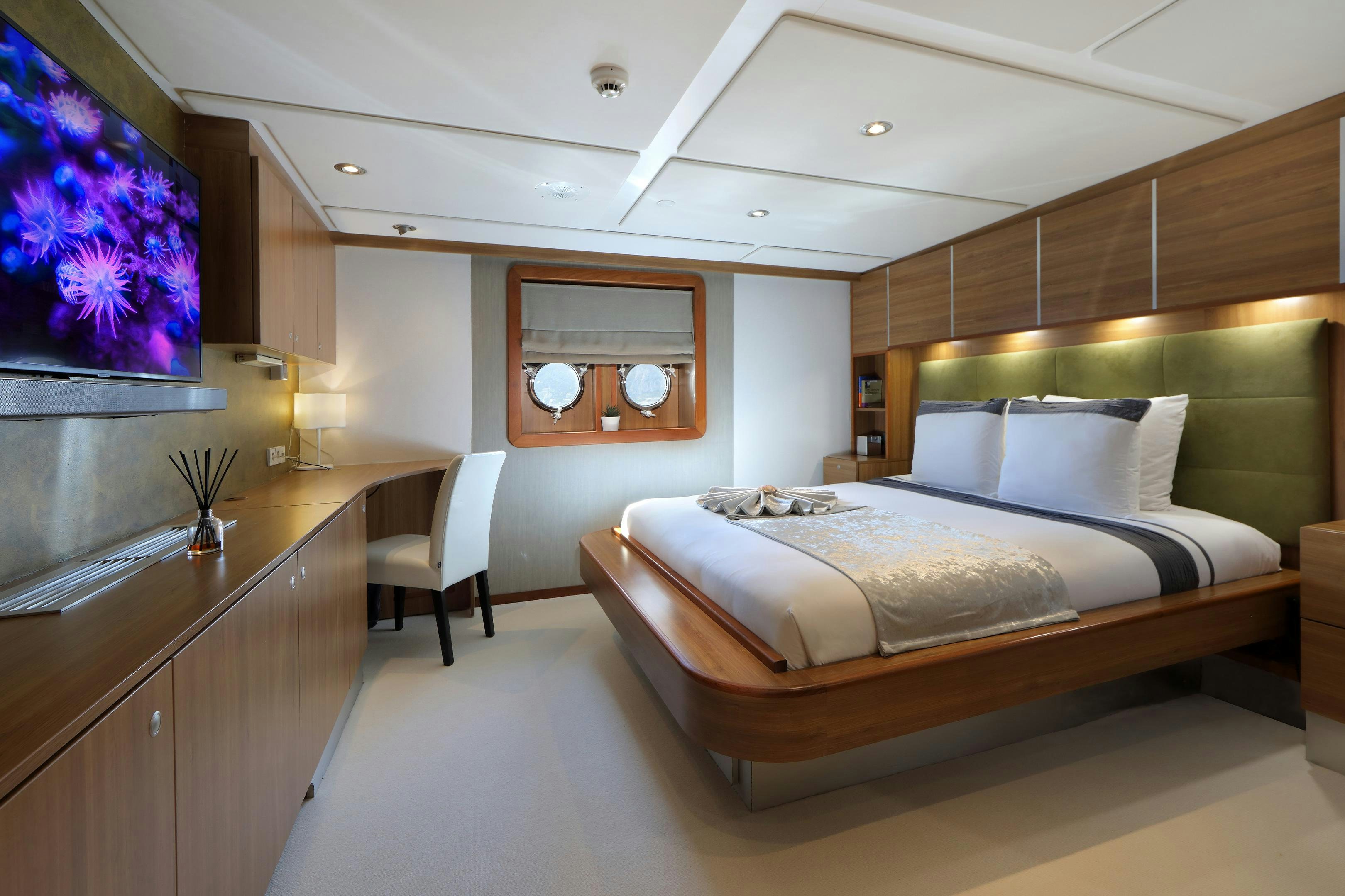 a bedroom with a large bed aboard SHERAKHAN Yacht for Charter
