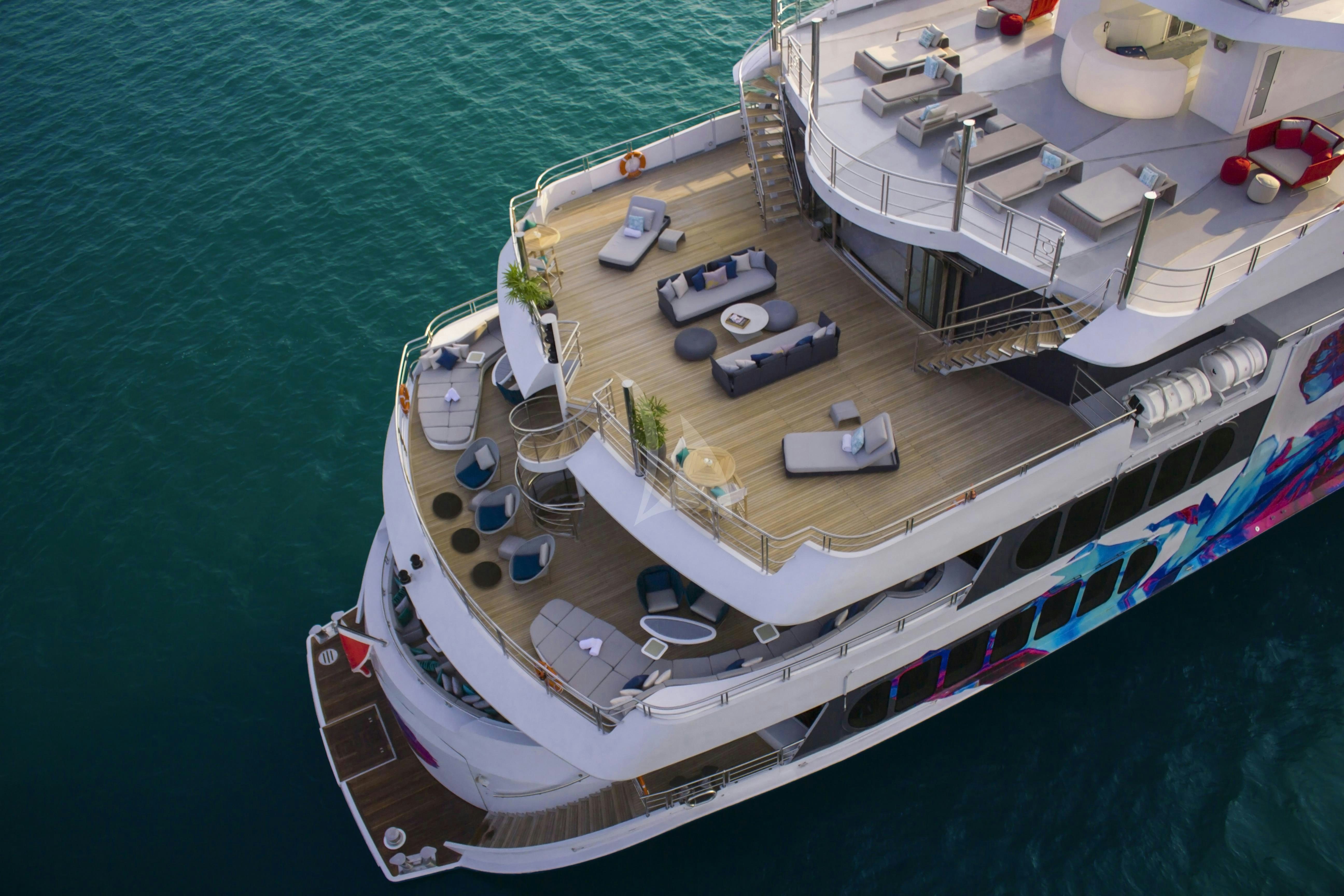 a large ship with a deck and a dock aboard SALUZI Yacht for Charter