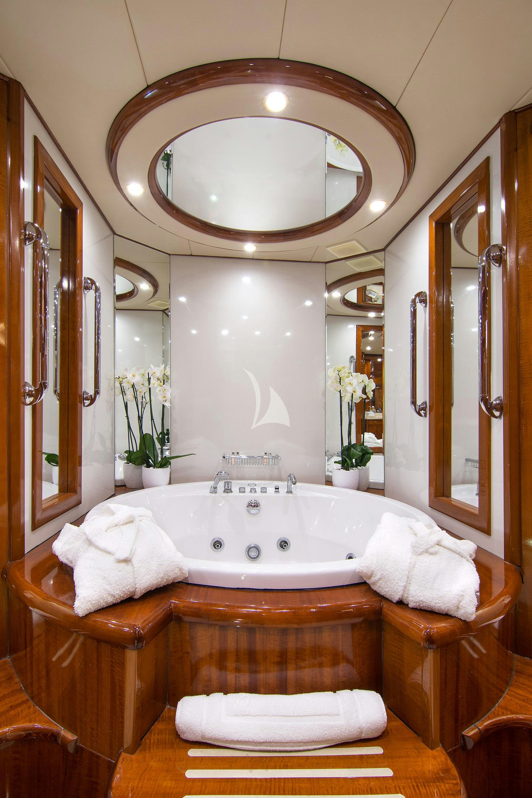 a large bathroom with a large round mirror aboard DREAM B Yacht for Charter