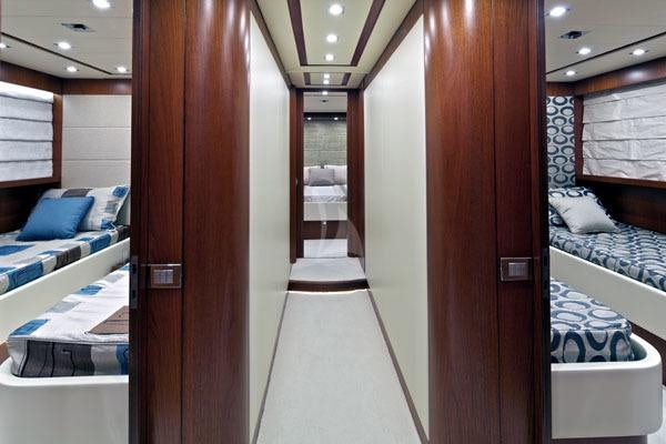 a room with a bed and a closet aboard BIANCA Yacht for Charter