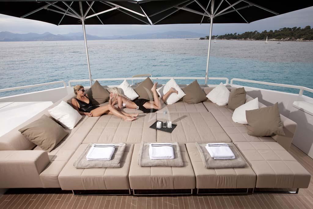 a couple sitting on a couch on a boat aboard SUN Yacht for Charter