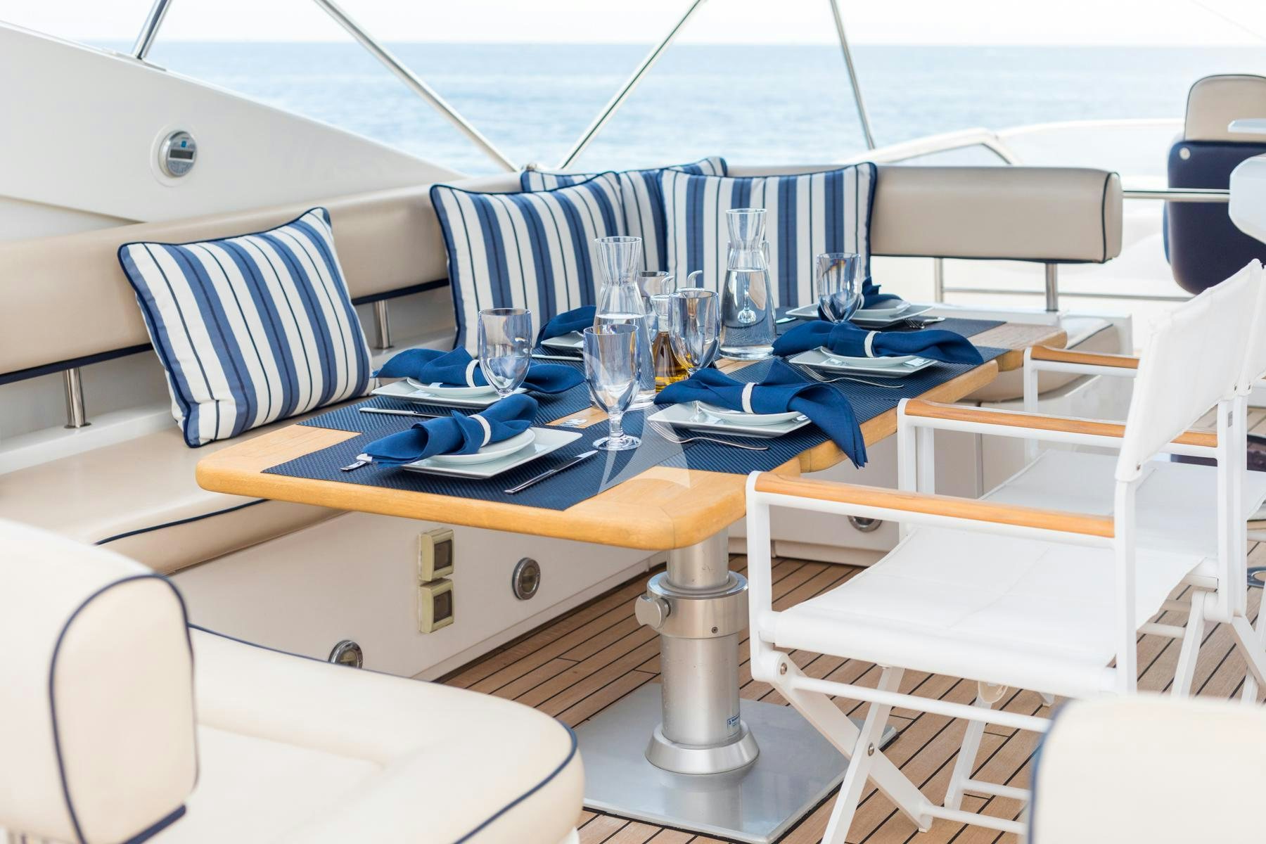 a table with chairs and a glass on it aboard WINNING STREAK 2 Yacht for Charter