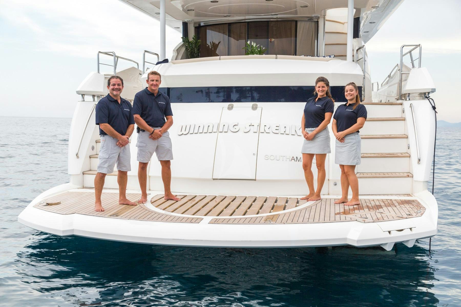 a group of people standing on a boat aboard WINNING STREAK 2 Yacht for Charter