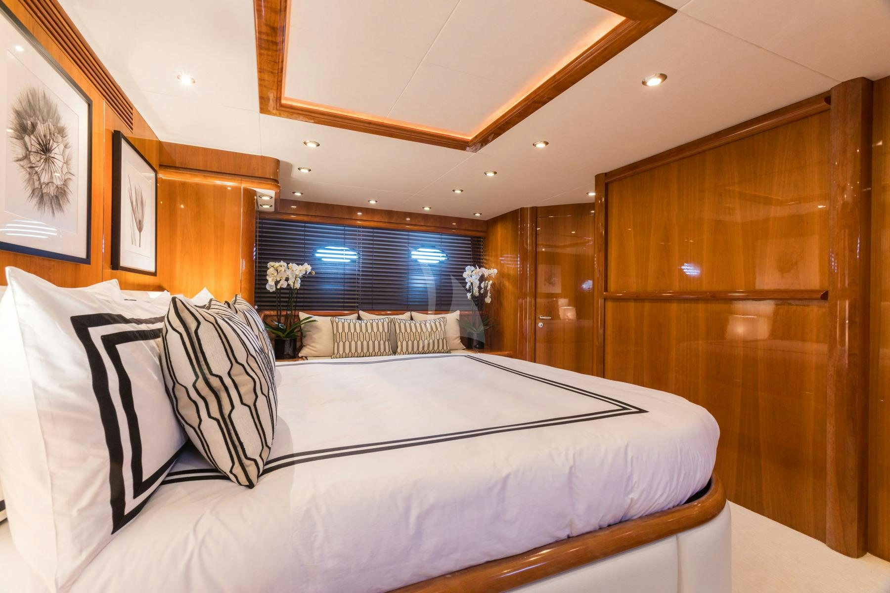 a large bed with white sheets aboard WINNING STREAK 2 Yacht for Charter