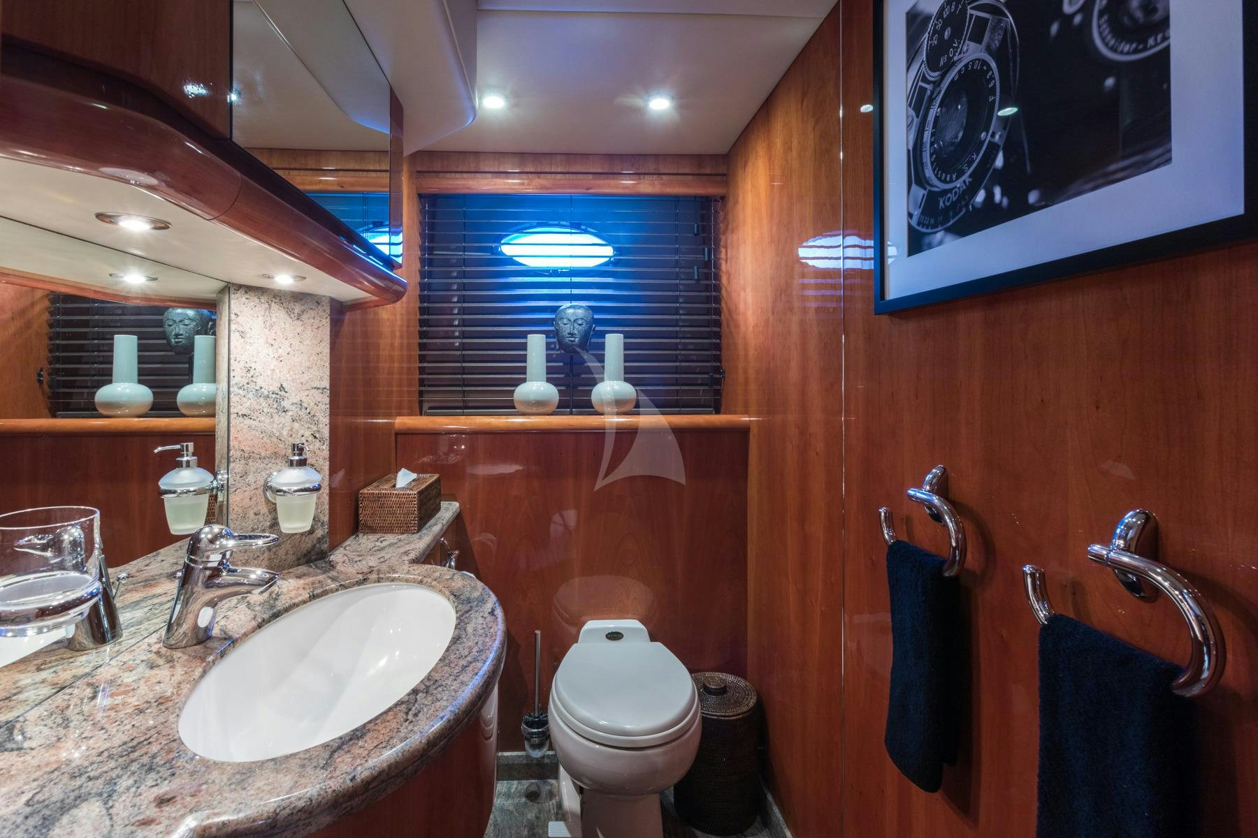 a bathroom with a sink toilet and a mirror aboard WINNING STREAK 2 Yacht for Charter