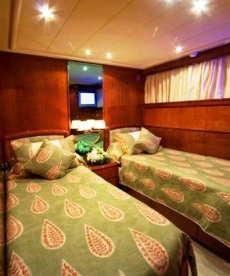 a couple of beds in a hotel room aboard OBSESSION Yacht for Charter